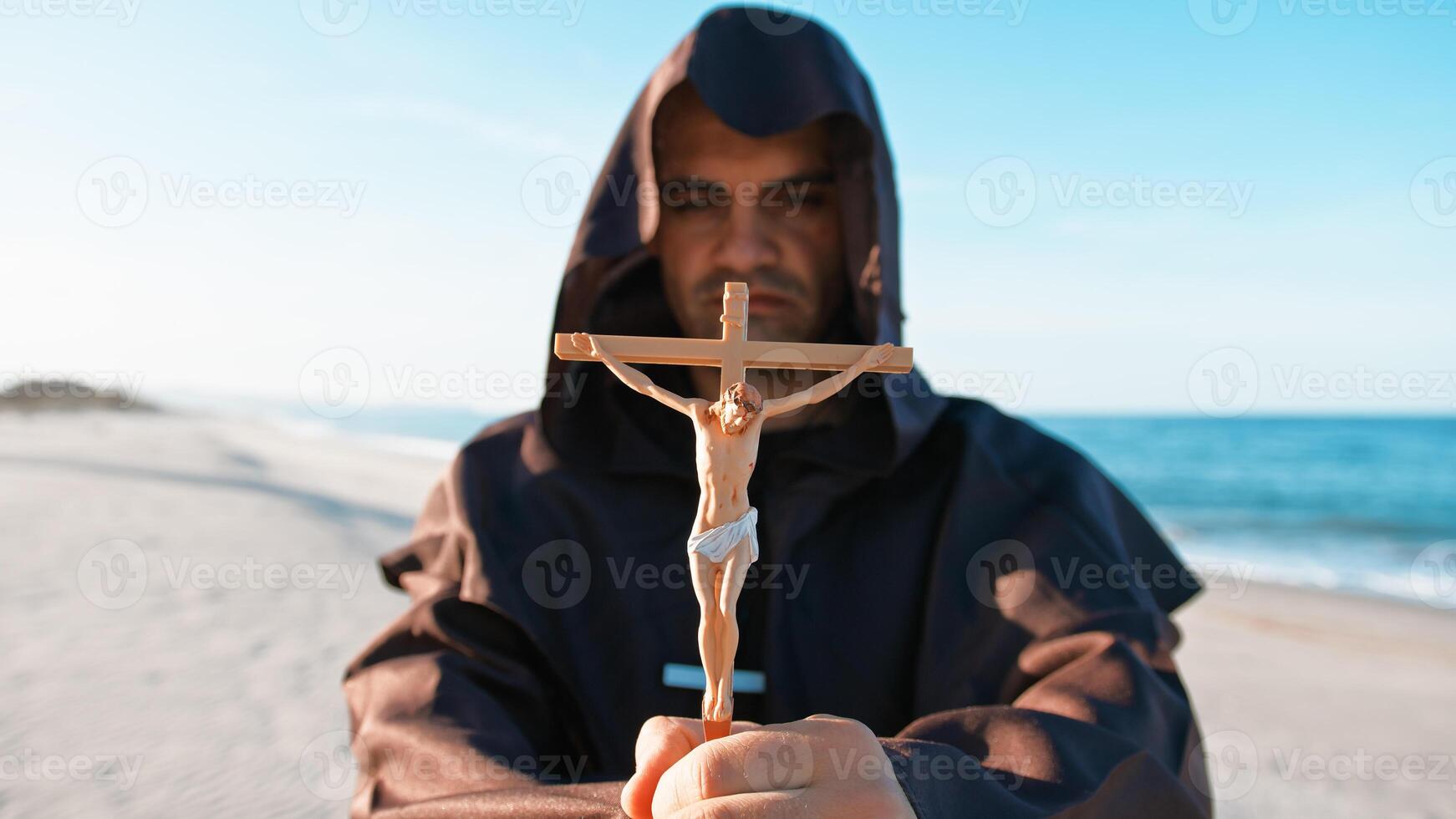 Jesus Crucifix In The Hands Of A Hooded Priest photo