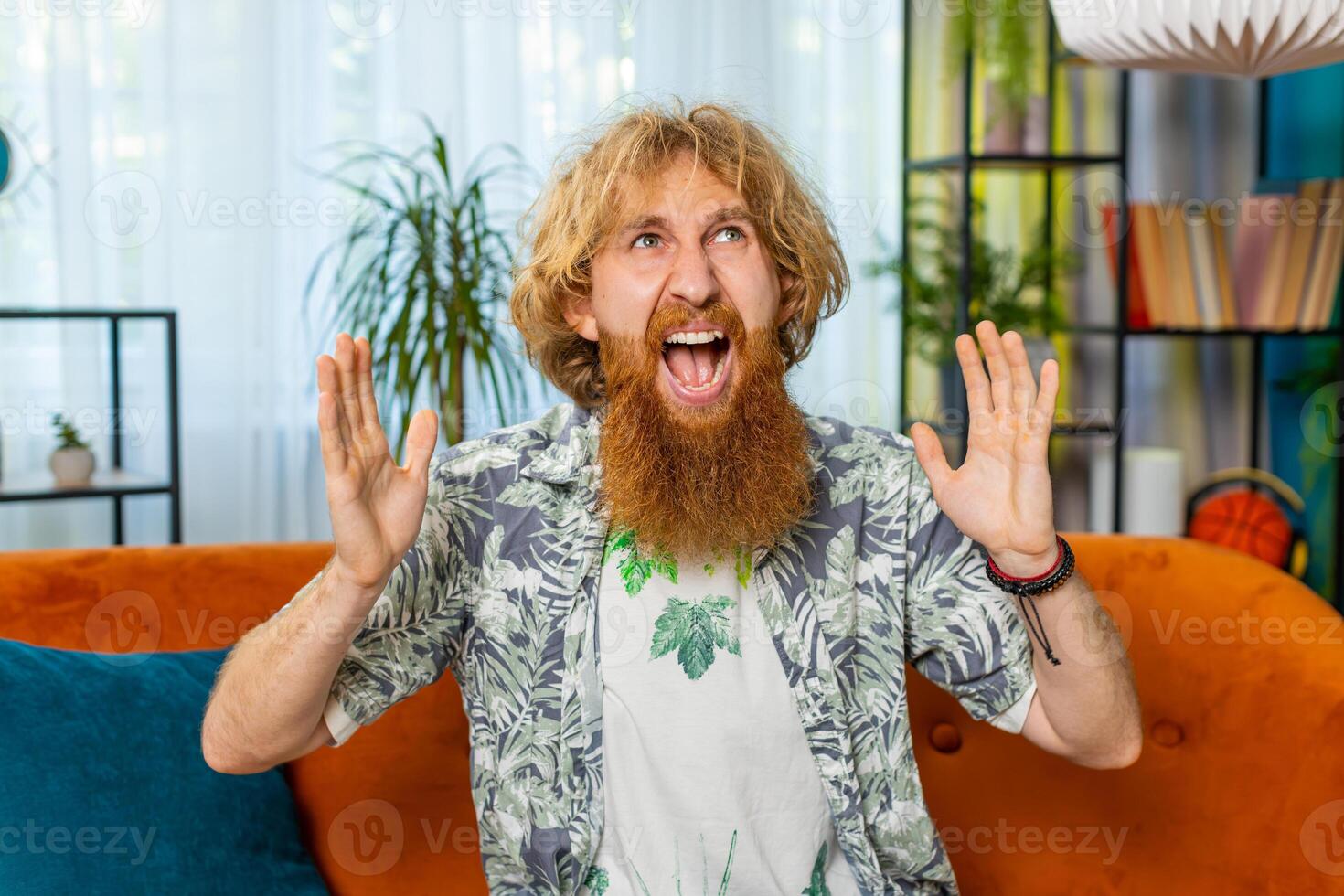 Aggressive man screams from stress tension problems panic hopelessness fear surprise shock nervous photo