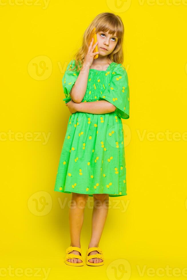 Tired sleepy child girl kid talking on smartphone with friend or mother annoyed boring online talk photo