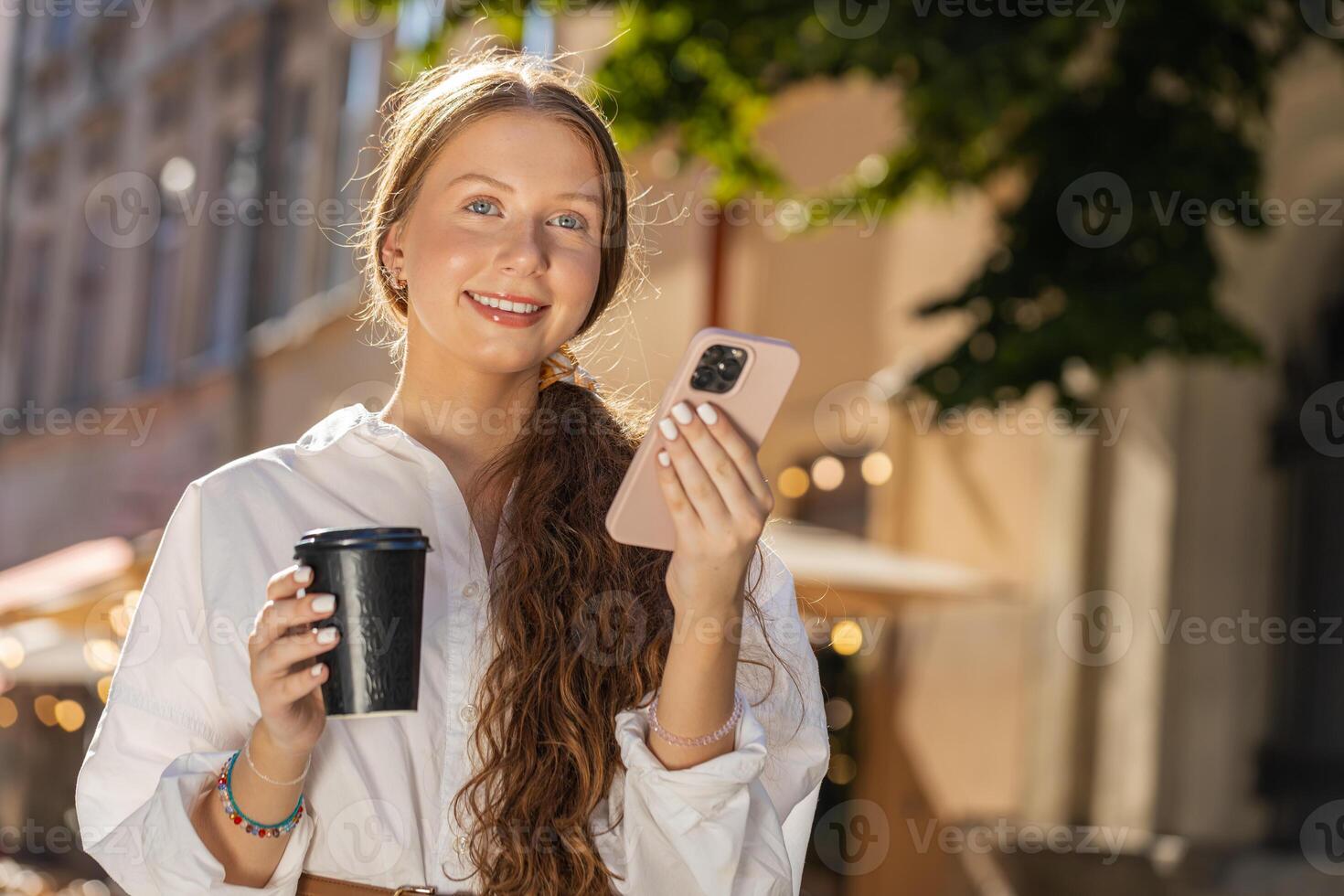 Teen girl woman enjoying drinking morning coffee hot drink, relaxing, taking a break in city street photo