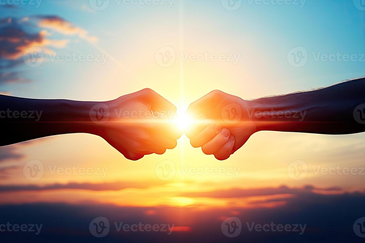 Two people holding hands in front of a sunset photo