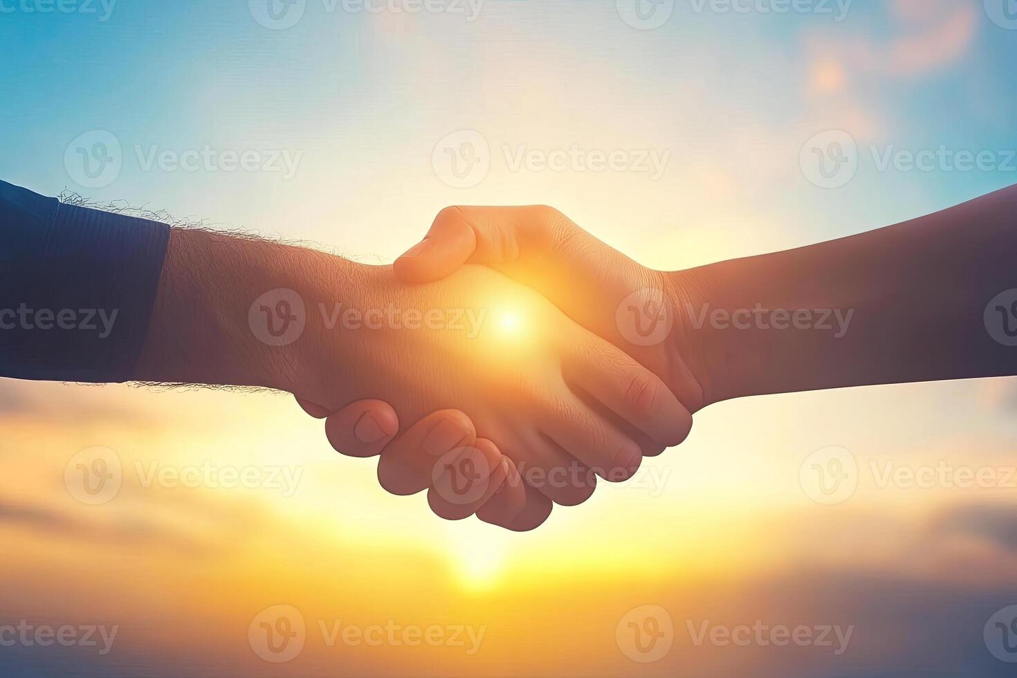 A handshake against a vibrant sunset photo
