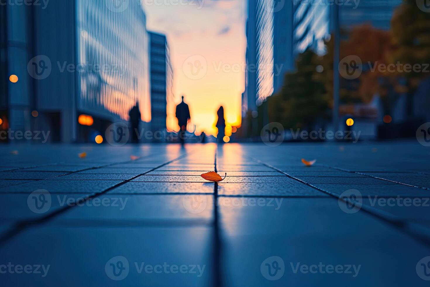 City street at sunset, pedestrians walking photo