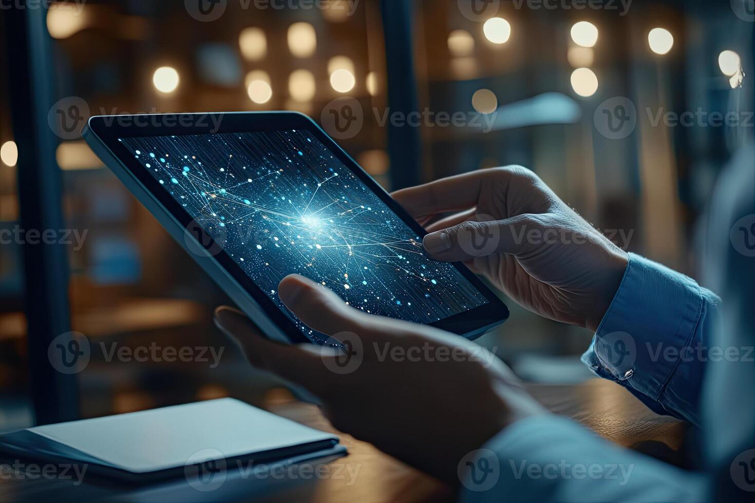 Person interacts with a tablet displaying neural network data photo