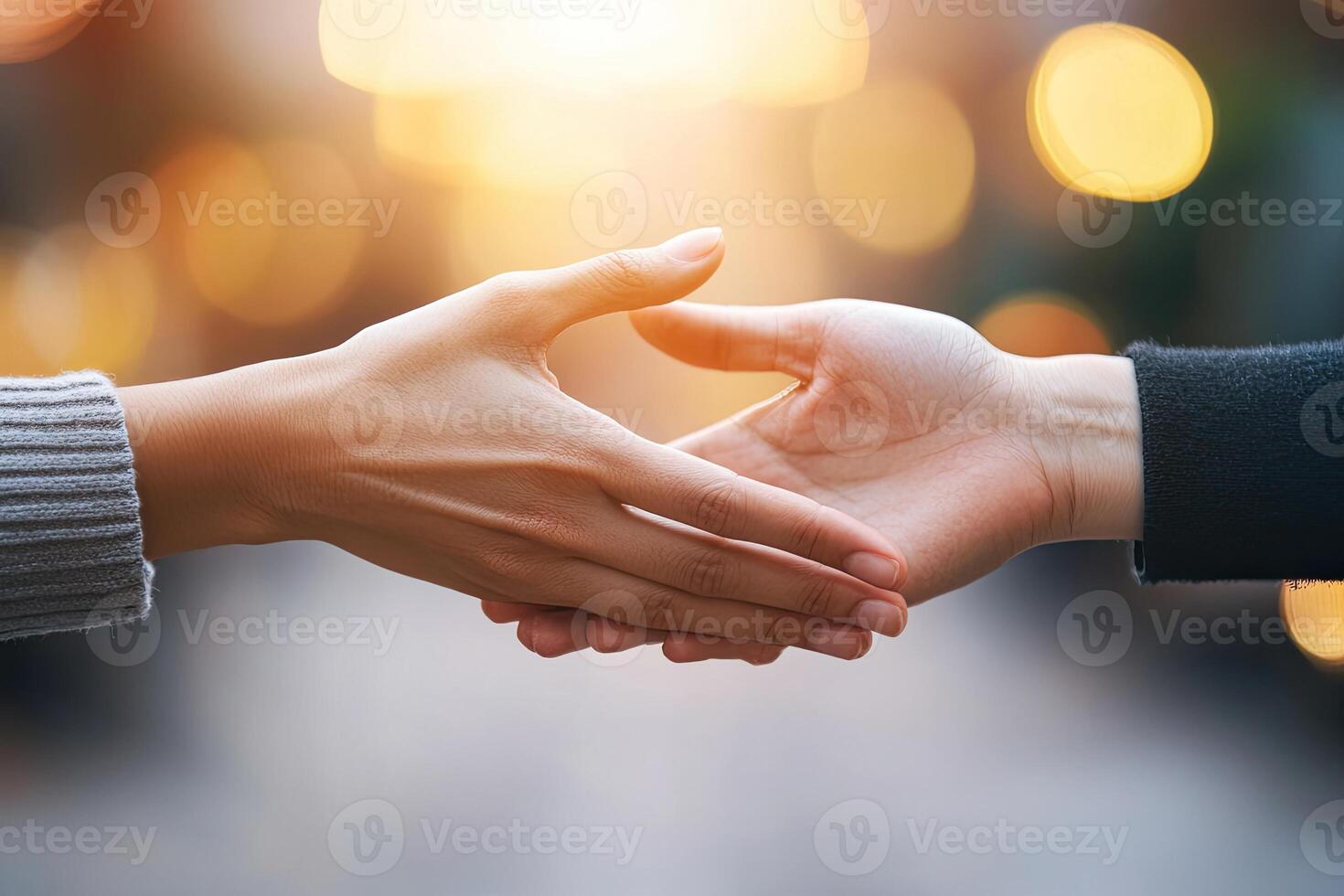 Two hands shaking in a friendly greeting photo