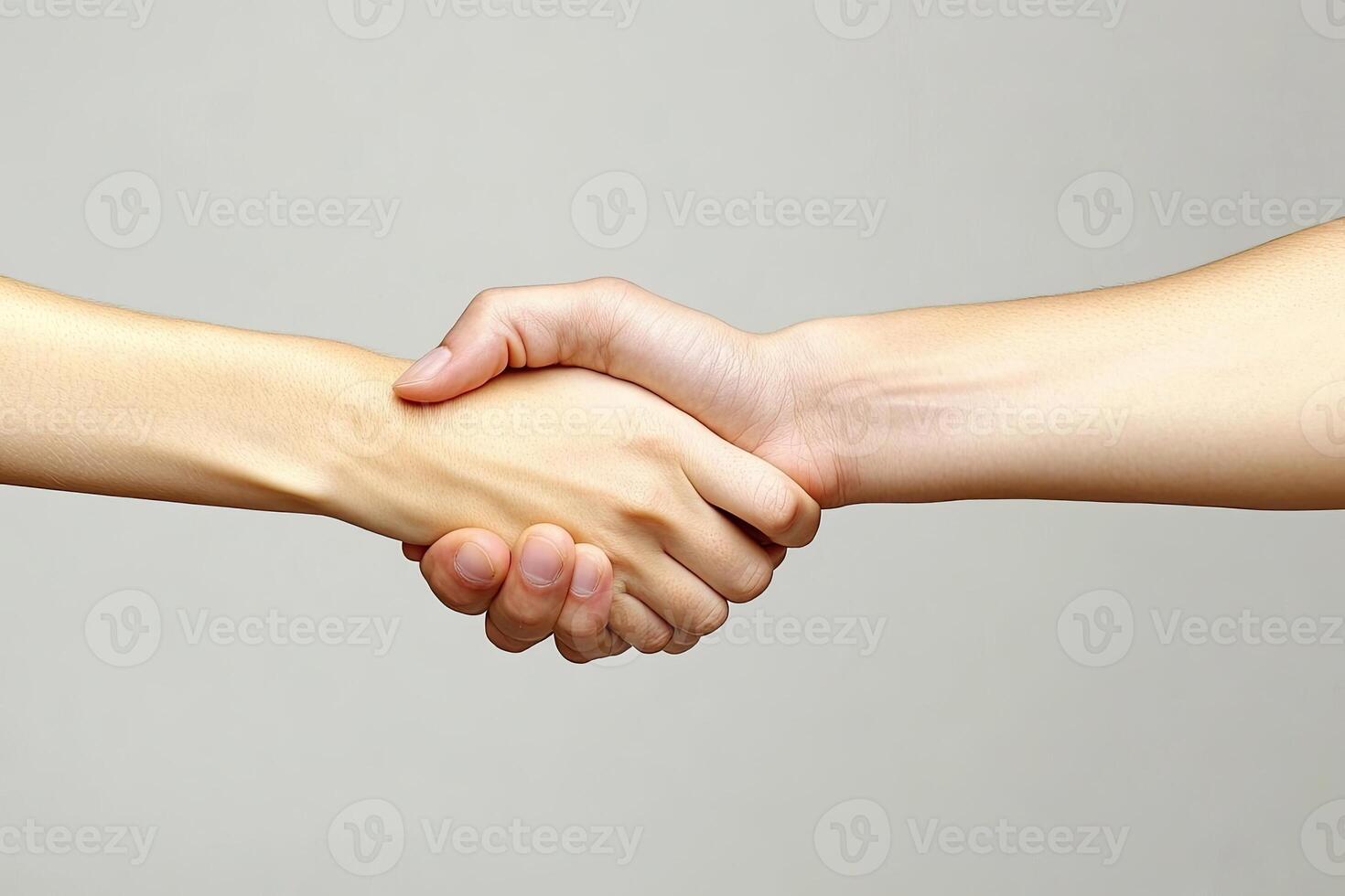 Two people shaking hands over a gray background photo