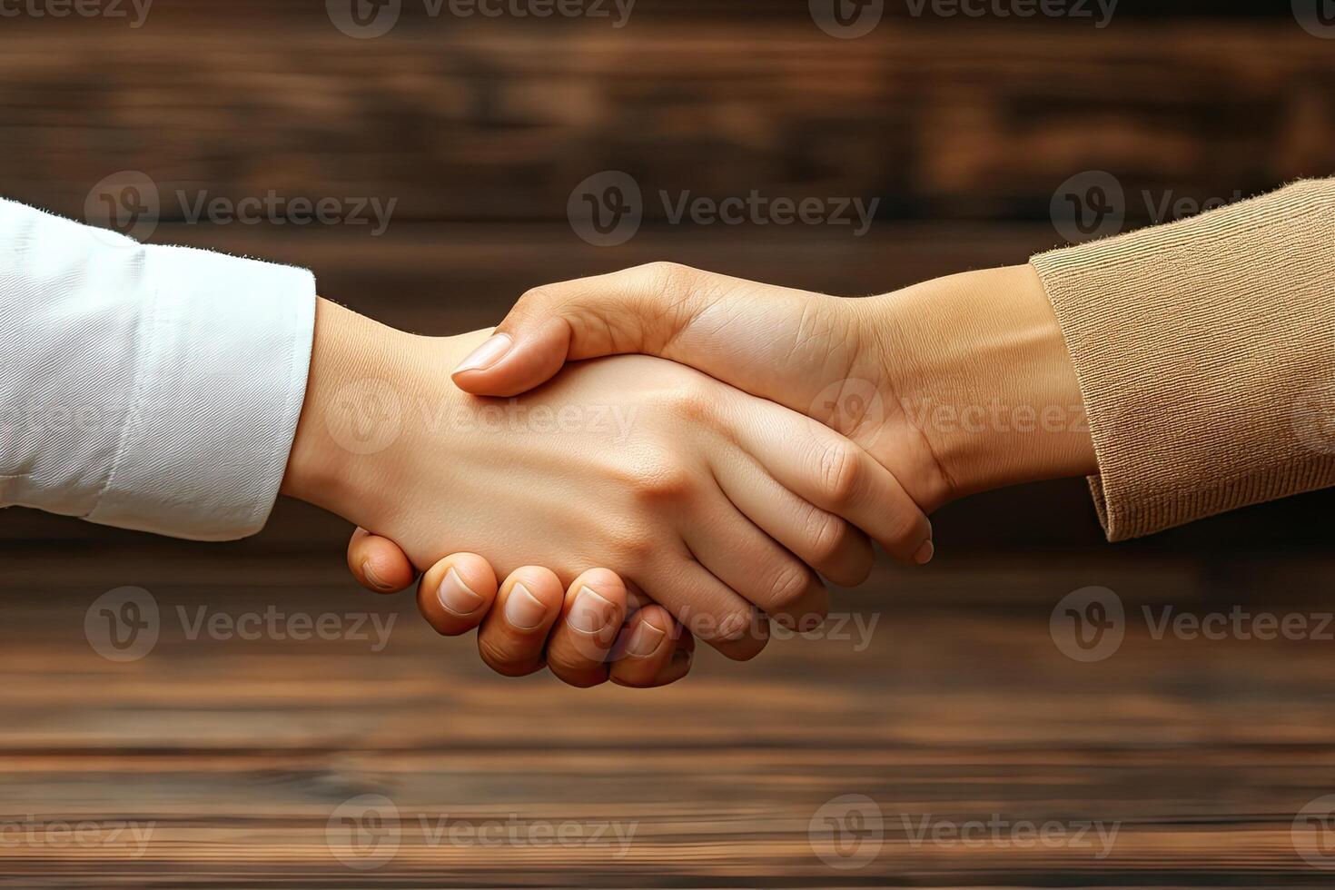 Business handshake on a wooden background photo