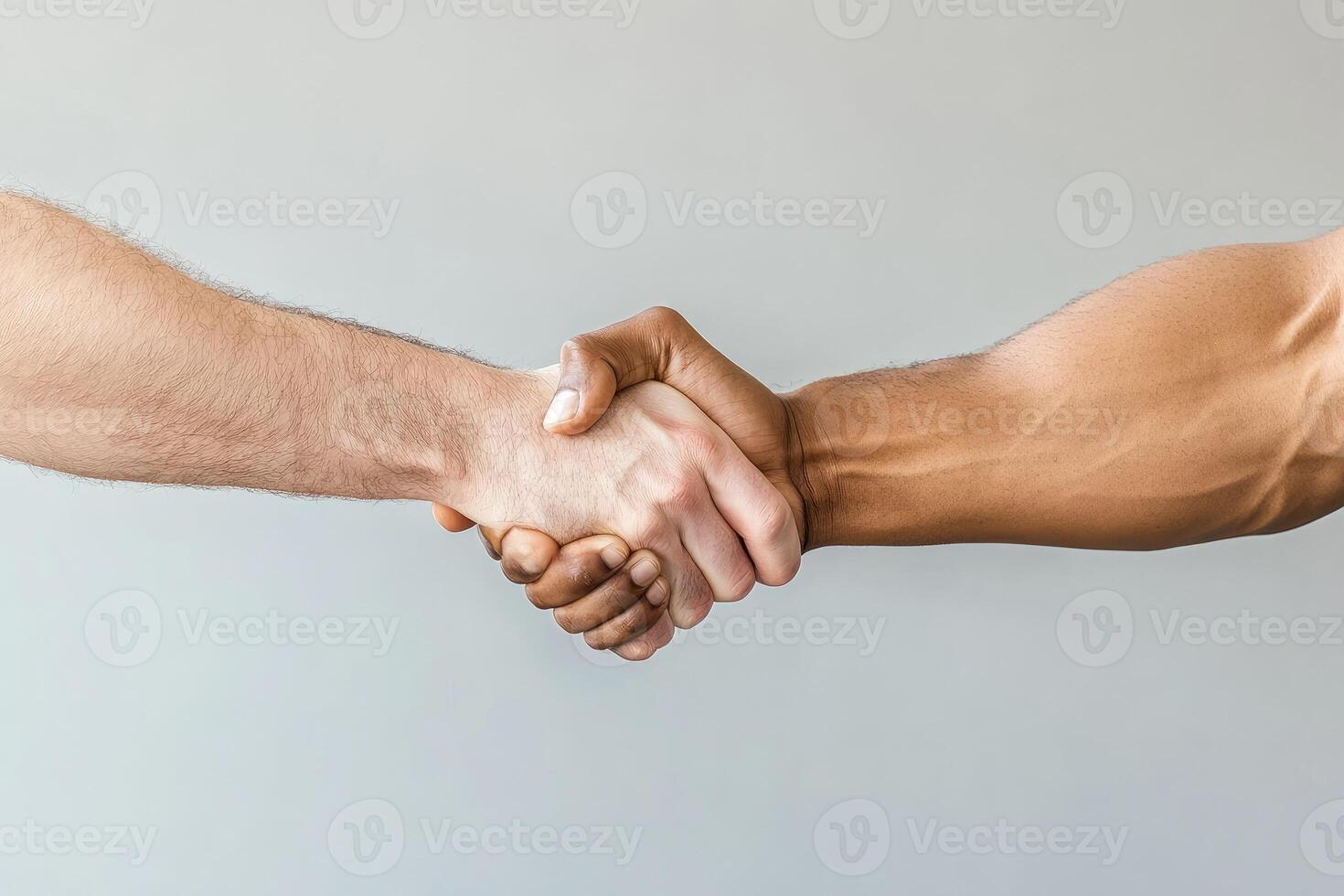 Two men shaking hands over a gray background photo
