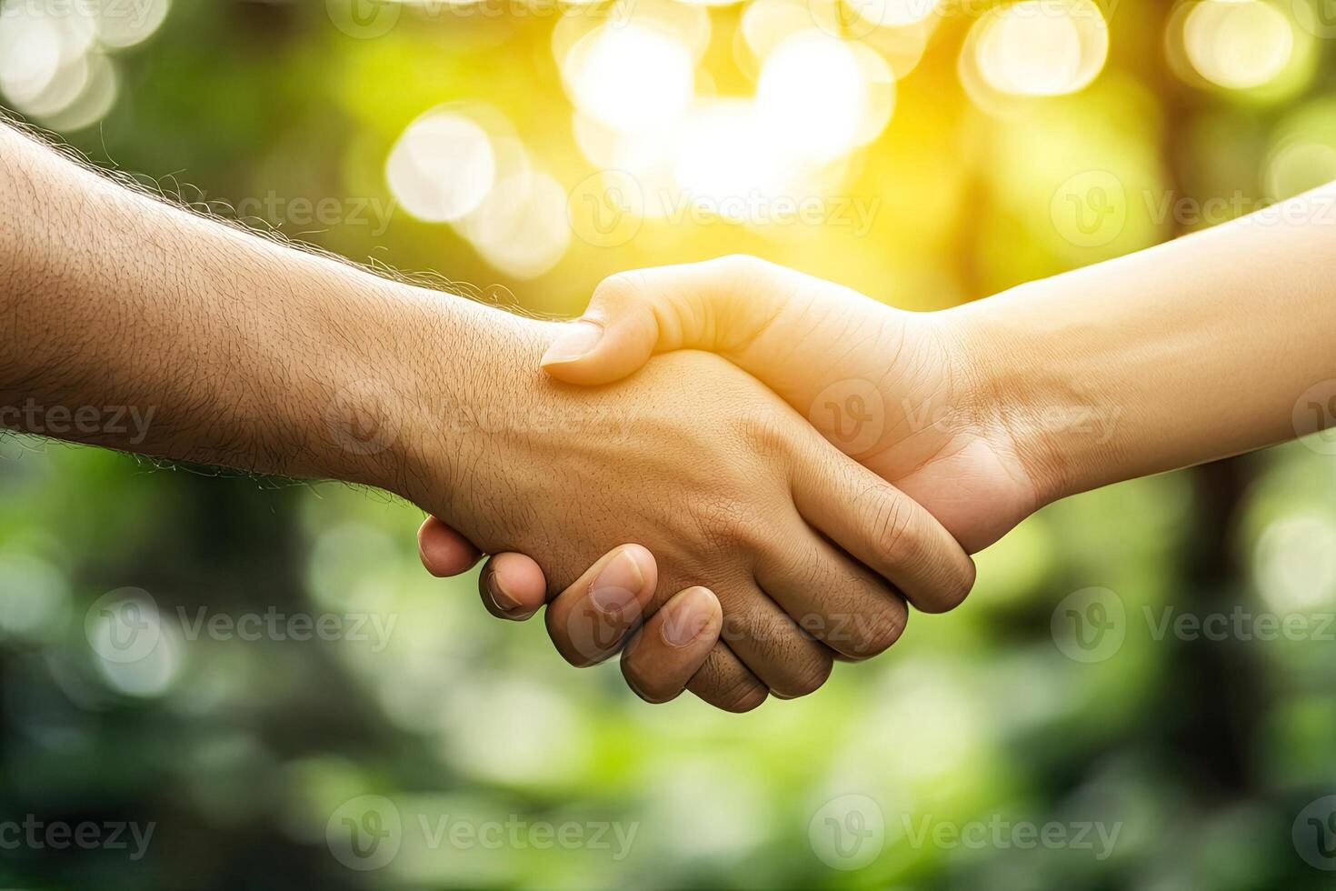 Two people shaking hands in front of a green background photo