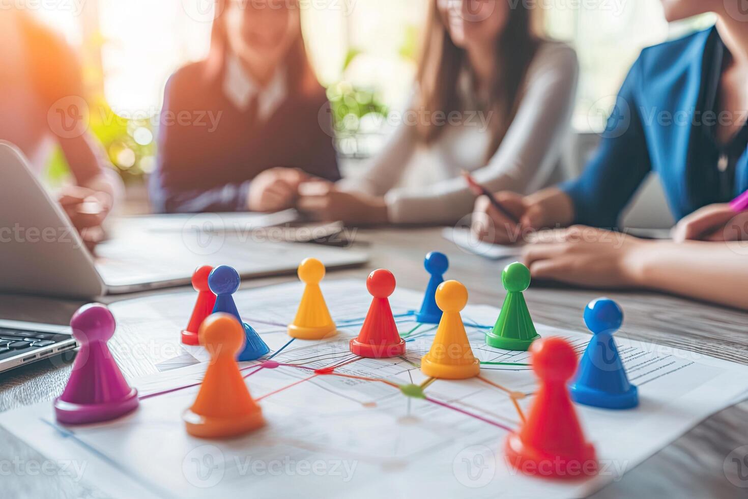 Team brainstorming session. Colorful game pieces on a shared document photo