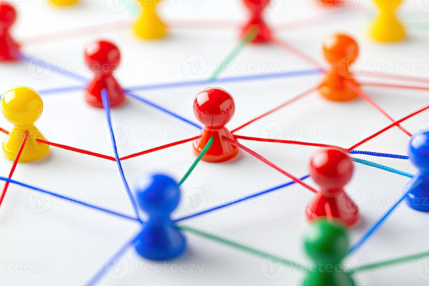 Colorful figurines interconnected by threads, forming a network photo