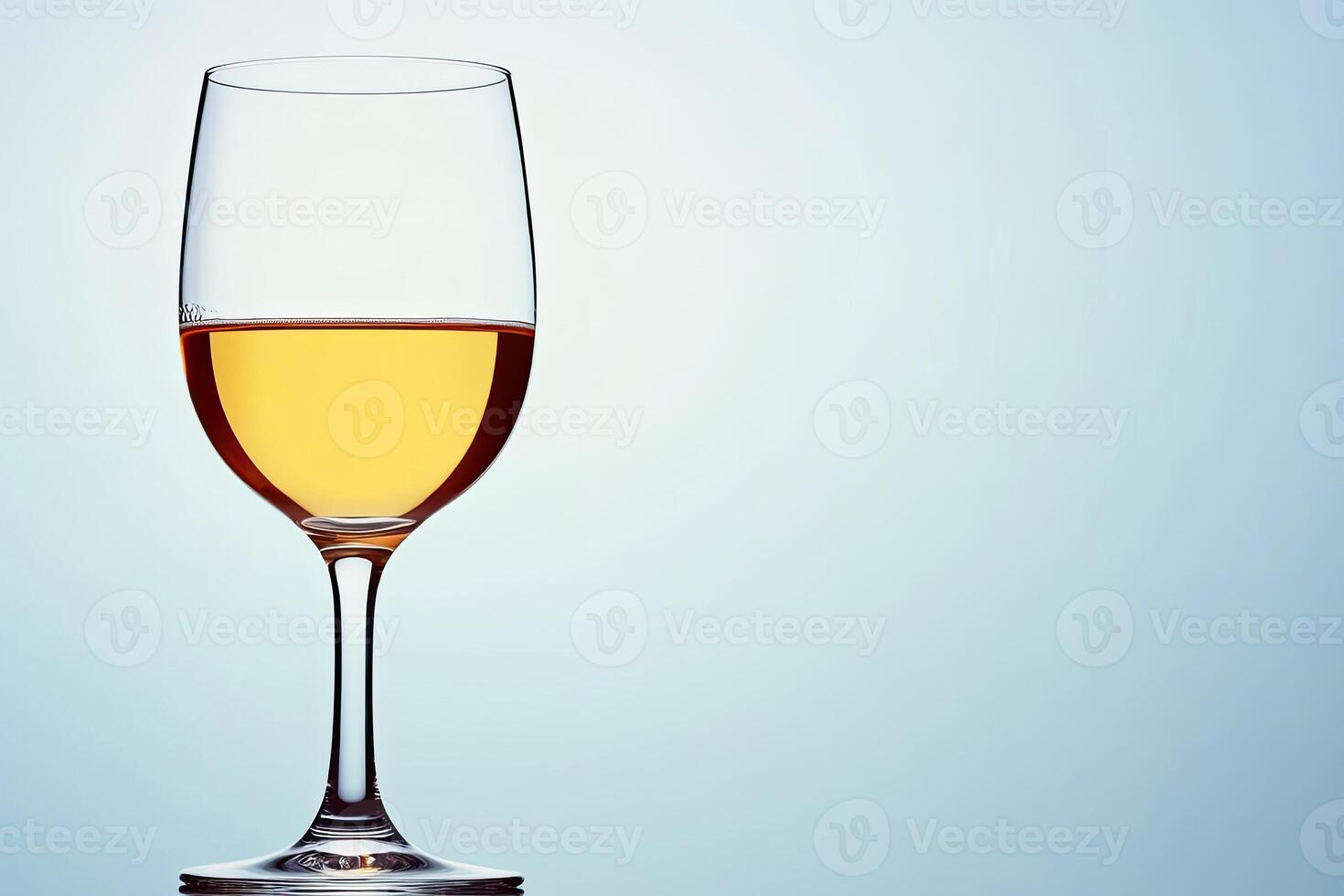 A glass of pale yellow wine photo