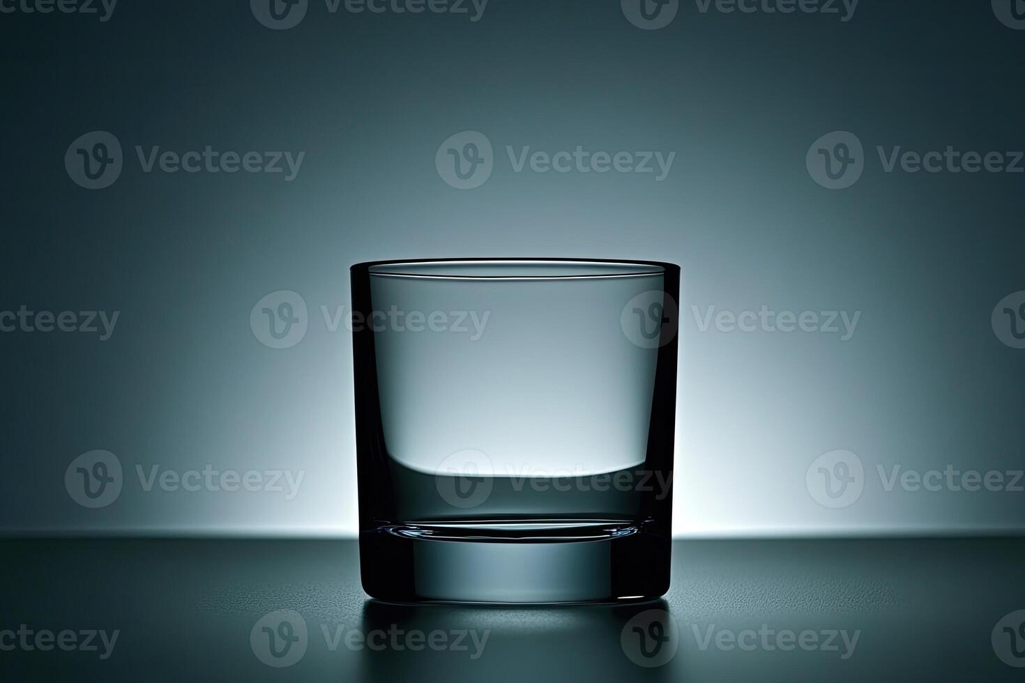 Empty shot glass on a dark surface photo