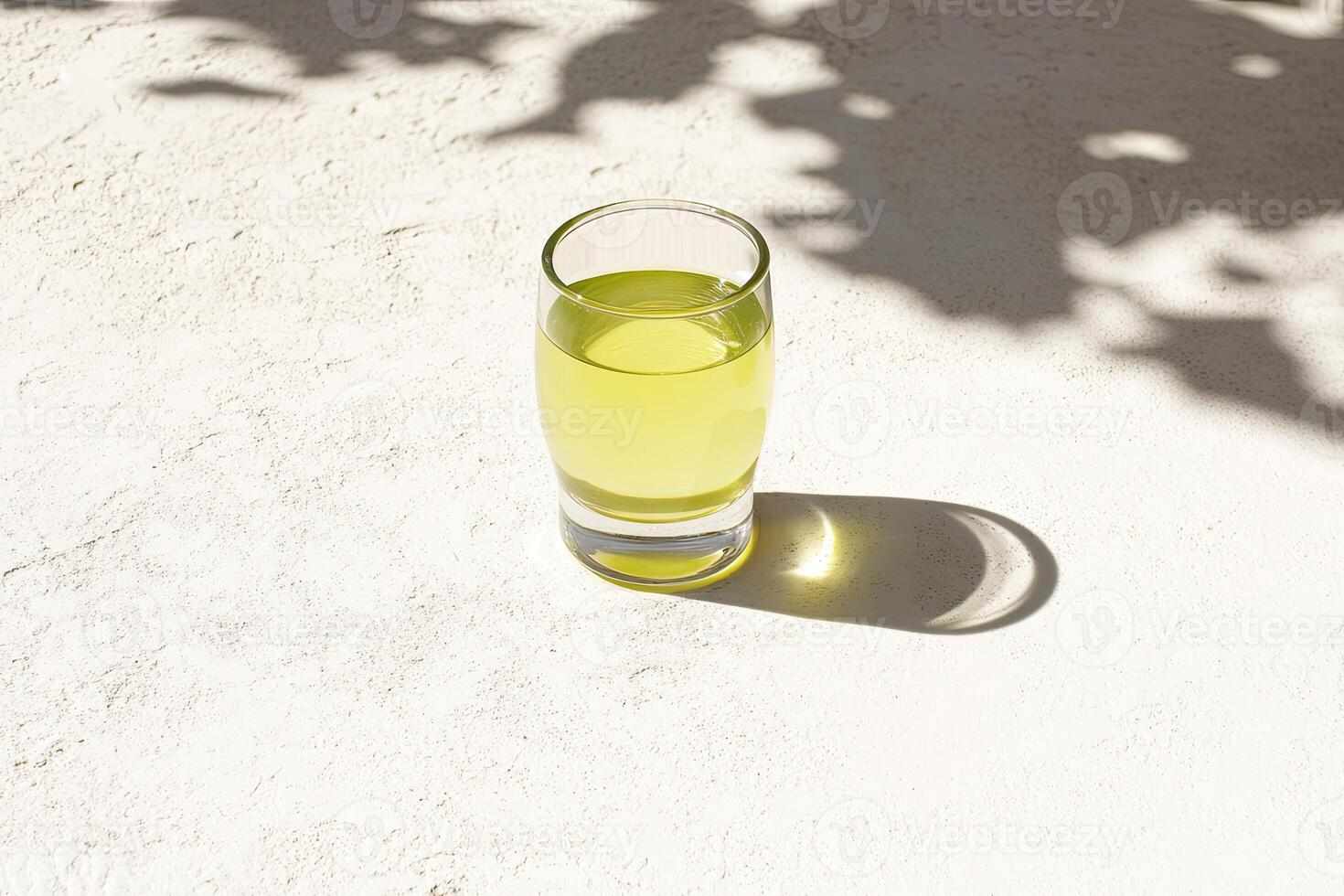 Pale yellow liquid in a shot glass photo