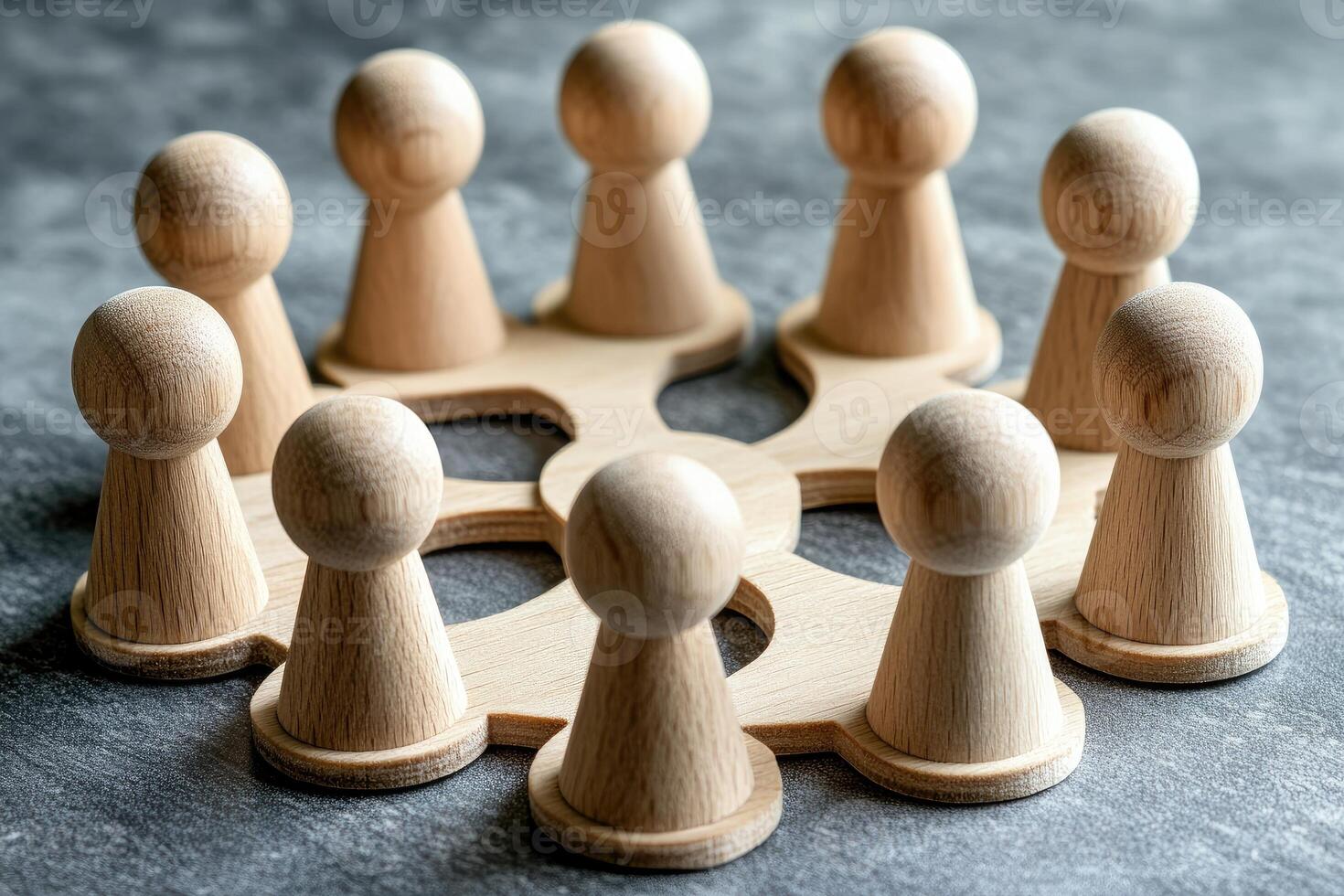 Wooden figures arranged in a circle, suggesting teamwork and collaboration photo