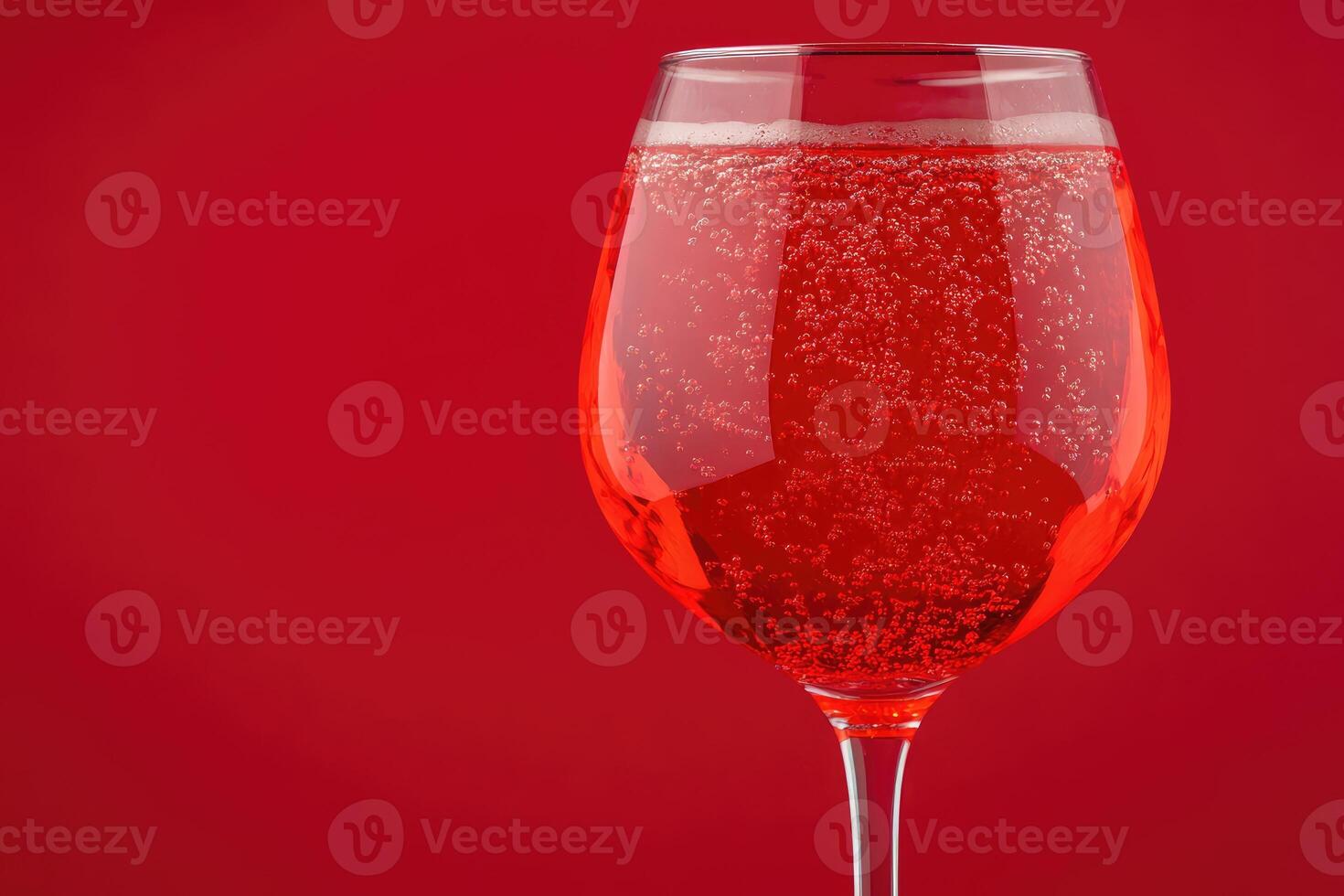 Sparkling red drink in a glass photo