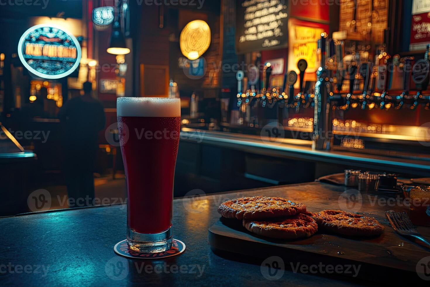 Red beer and snacks at bar photo