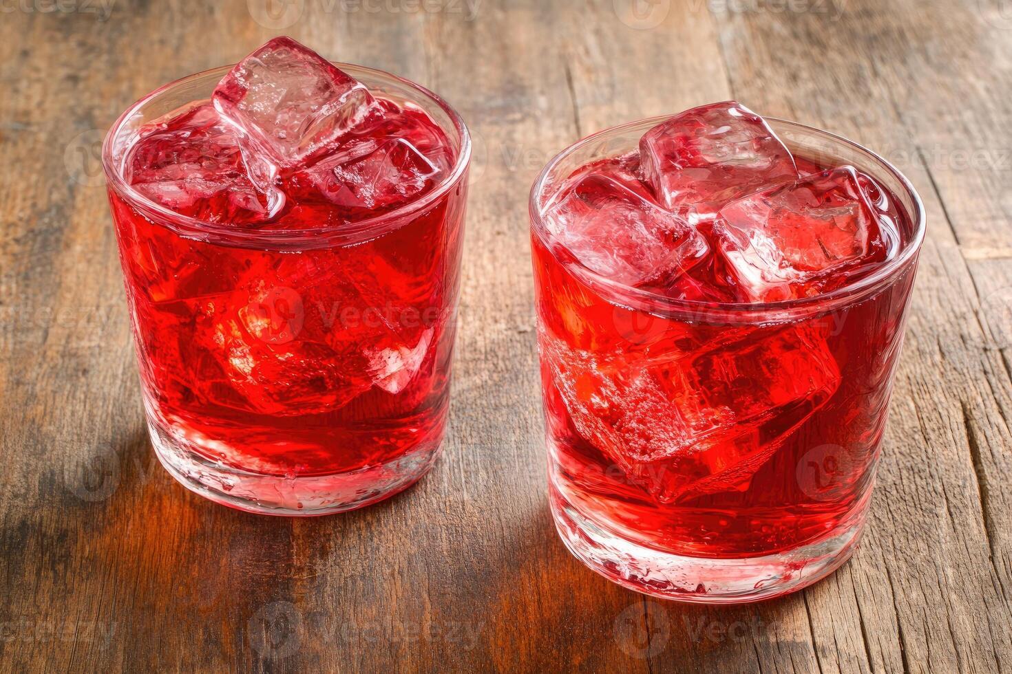 Two chilled ruby red drinks with ice cubes photo