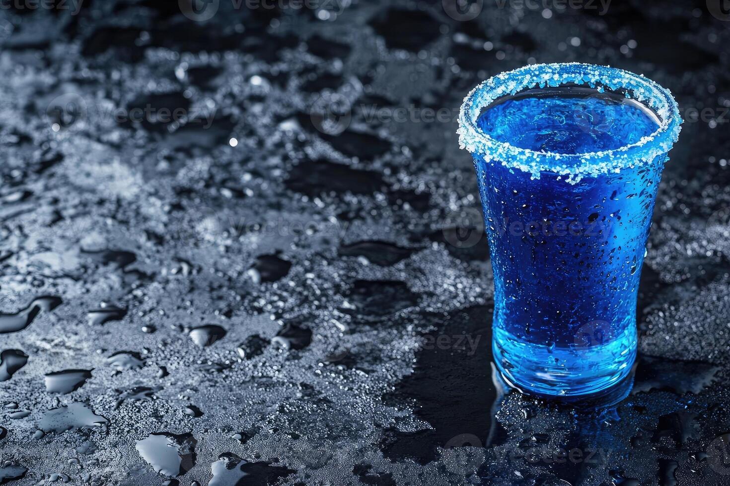 Blue cocktail shot glass on a dark surface photo