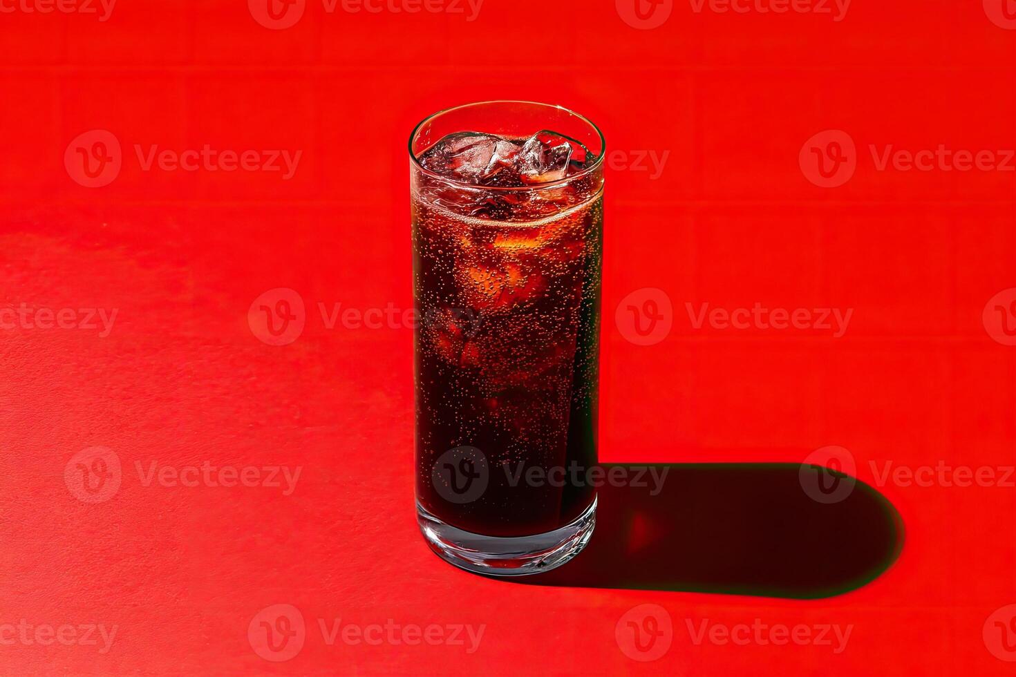 Sparkling dark drink in a glass with ice photo