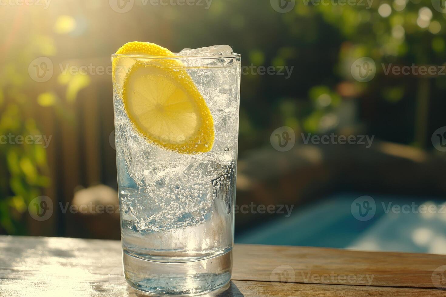 A glass of water with lemon on top photo