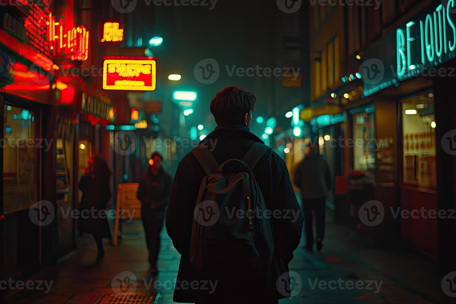 Nighttime city street scene with pedestrian photo