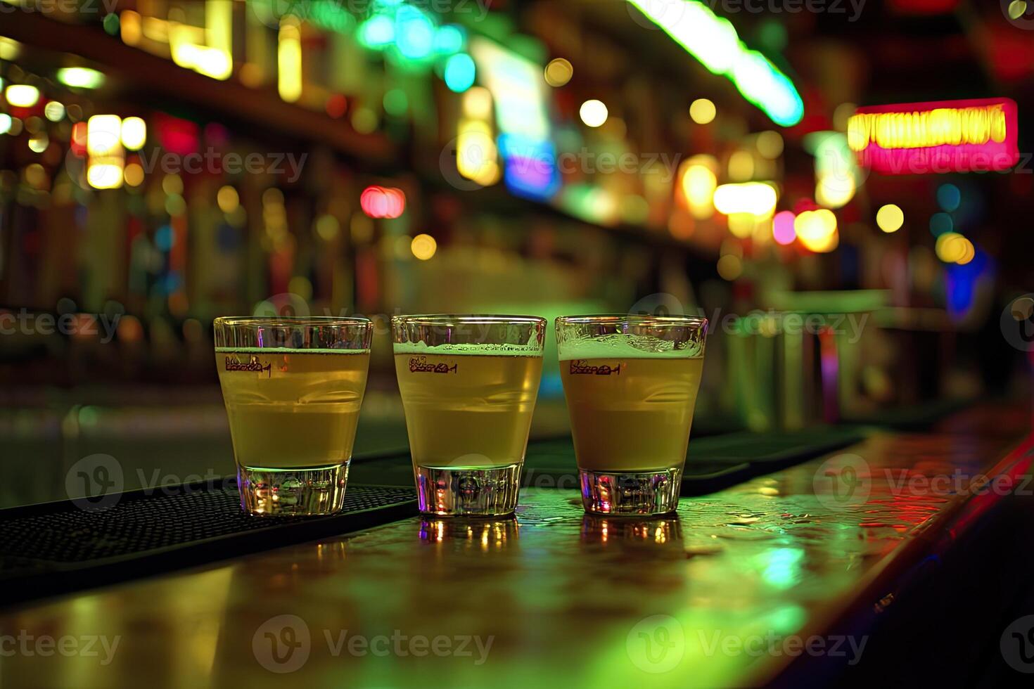 Three small beer glasses on a bar top photo