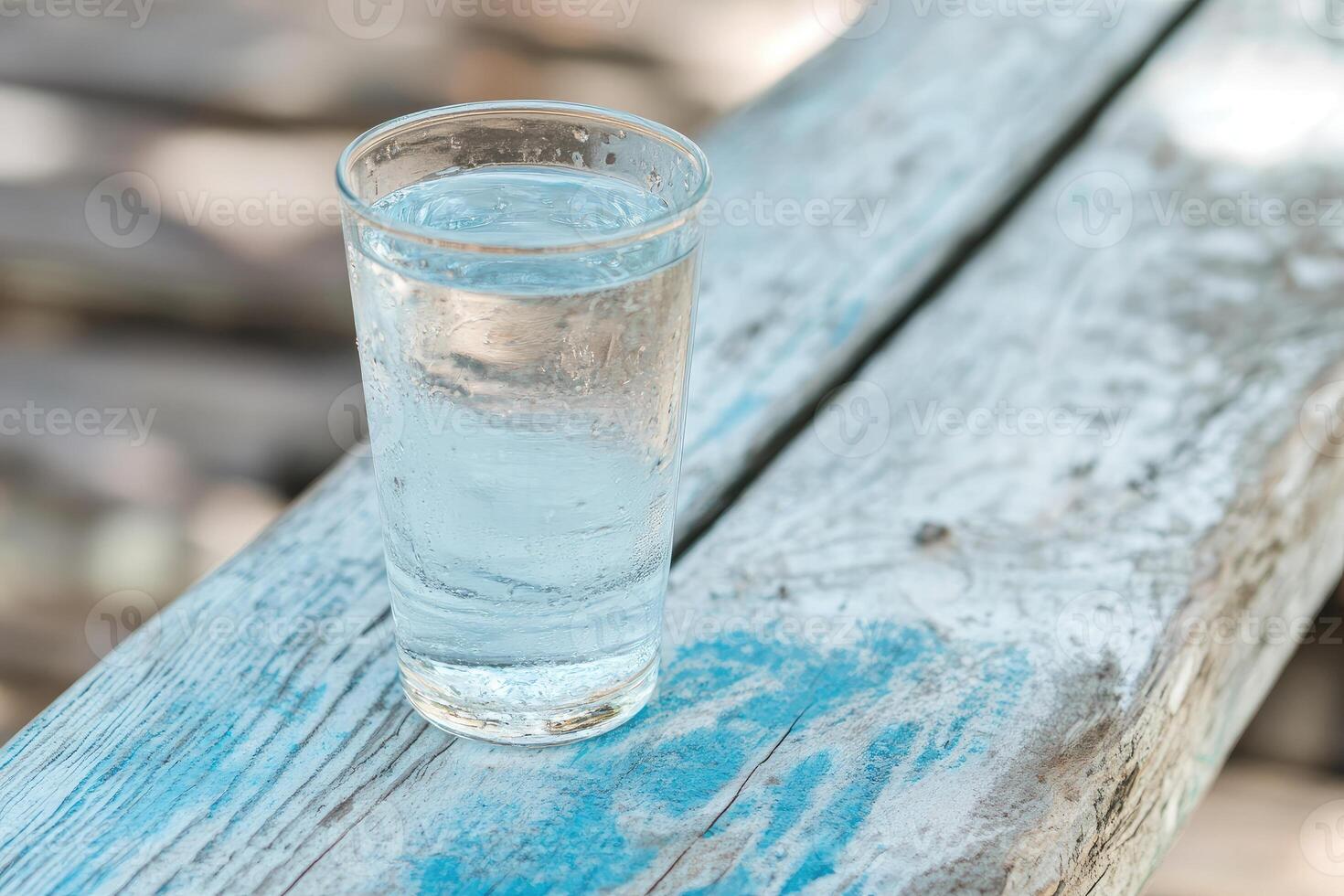 Cool water in a glass on a weathered wooden surface photo