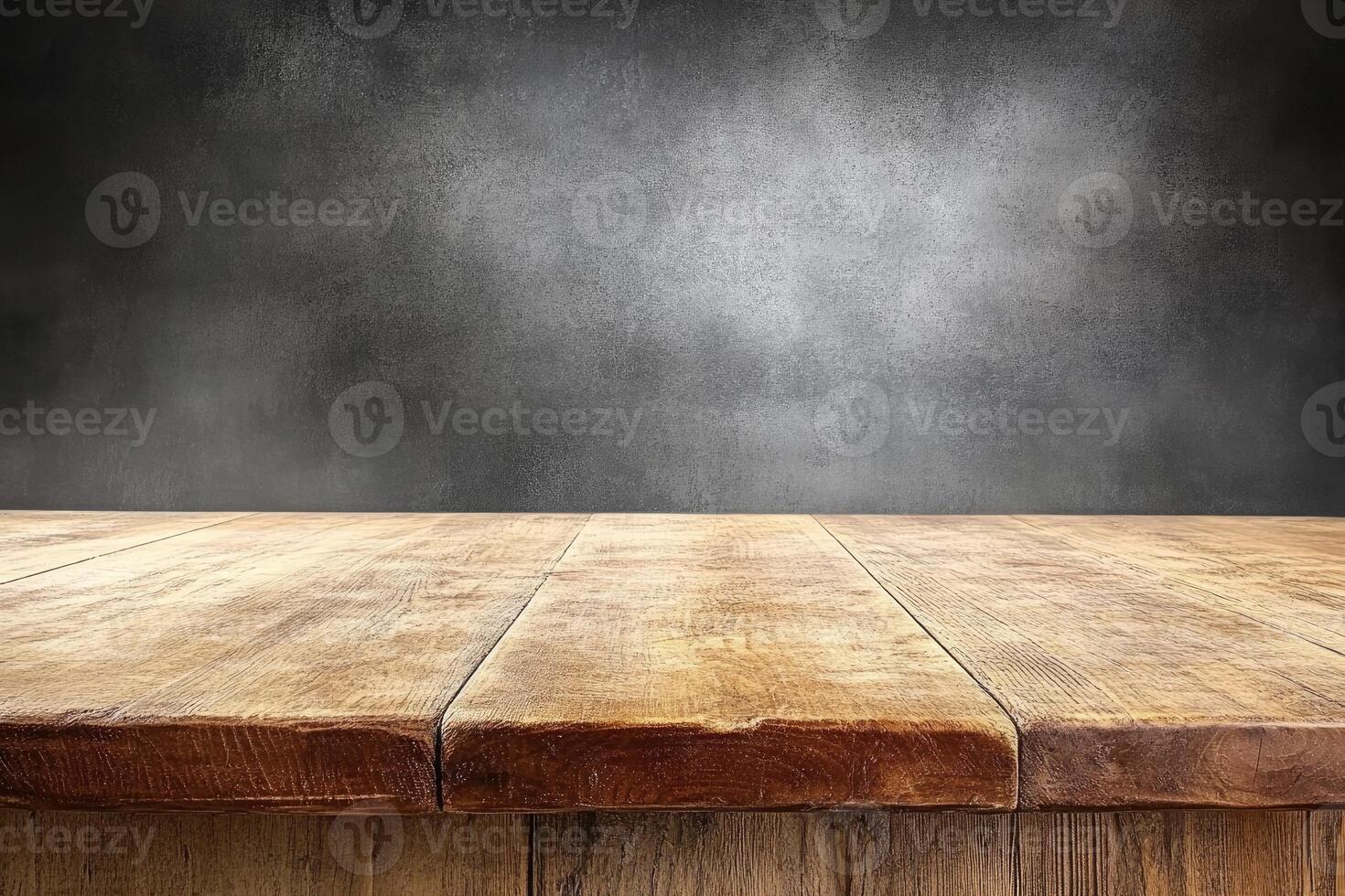 Wooden table top against a dark, textured wall photo