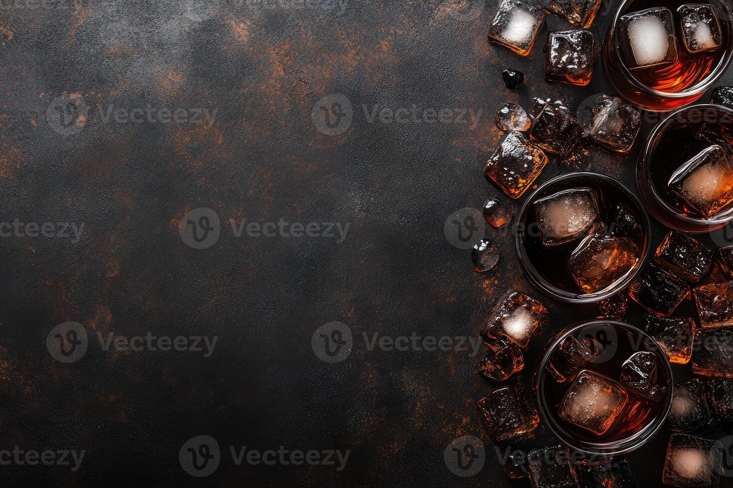 Dark drinks with ice on a rustic surface photo