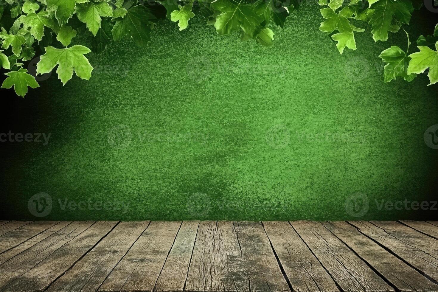 Green wall with wooden floor, fresh leaves photo