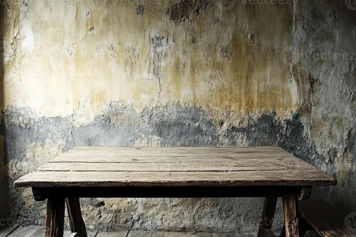Rustic wooden table against aged wall photo
