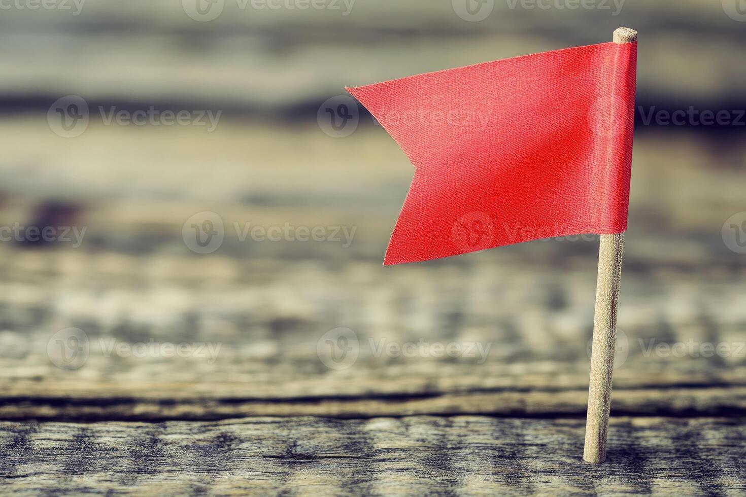Small red flag on weathered wood photo