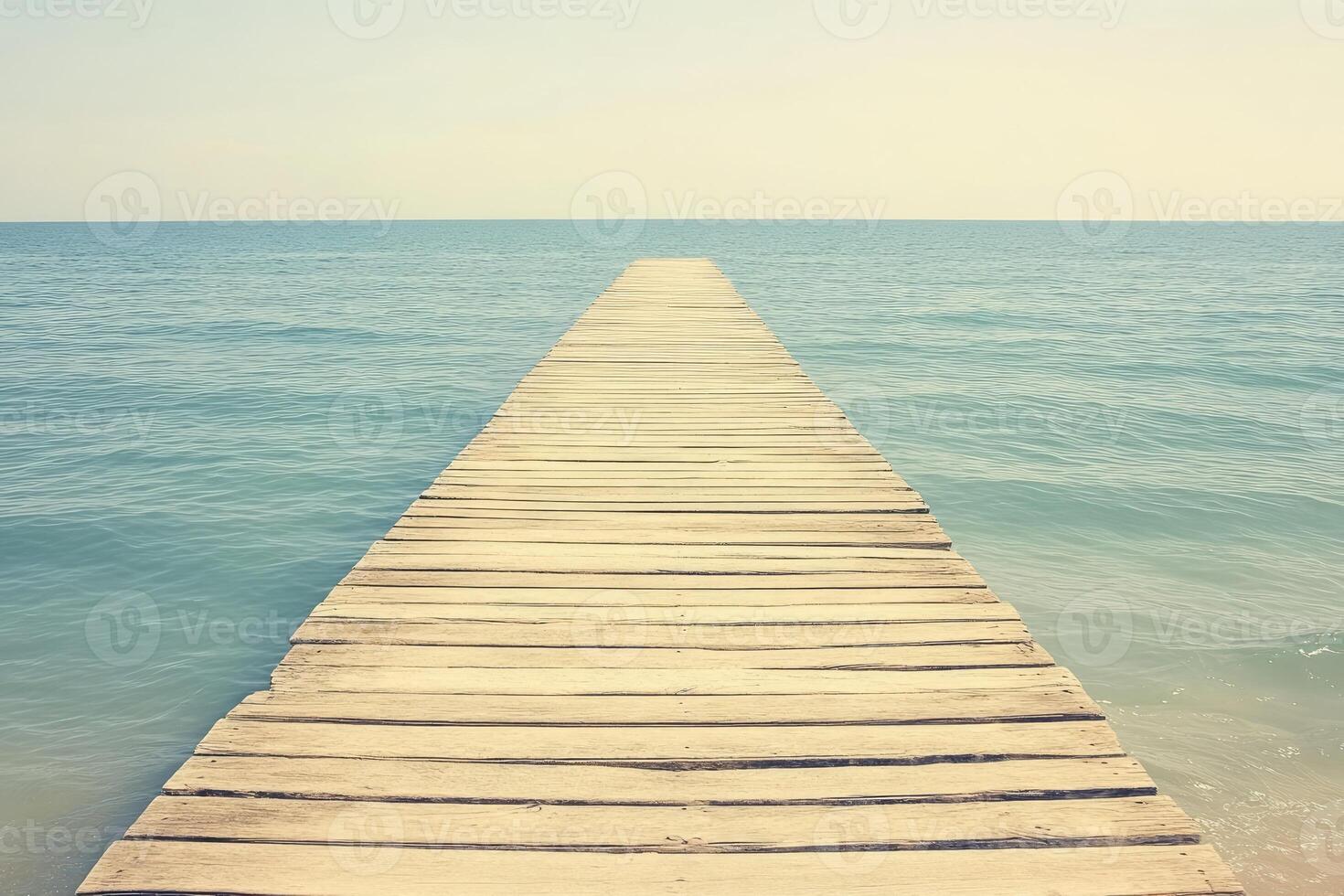 Tranquil wooden dock extends into serene ocean photo
