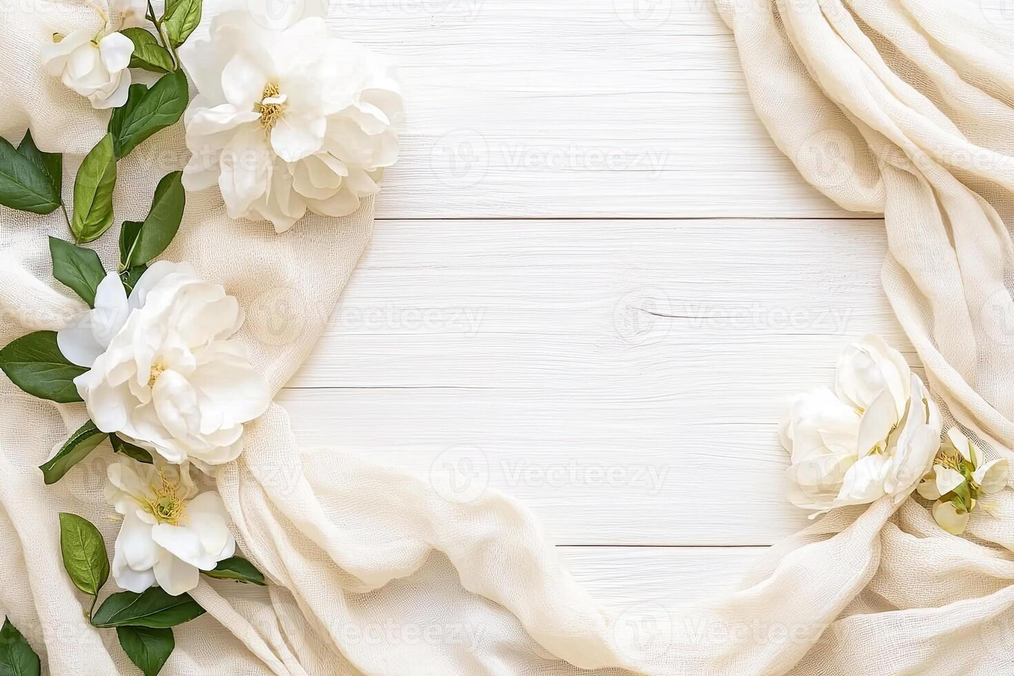 Delicate white flowers and cream fabric on a white wooden background photo