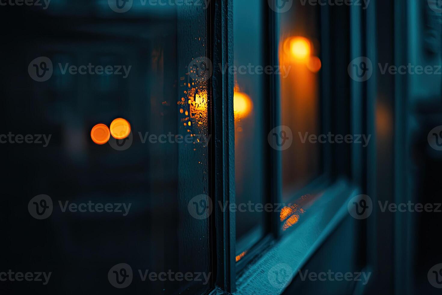 Rainy window, warm light reflections photo