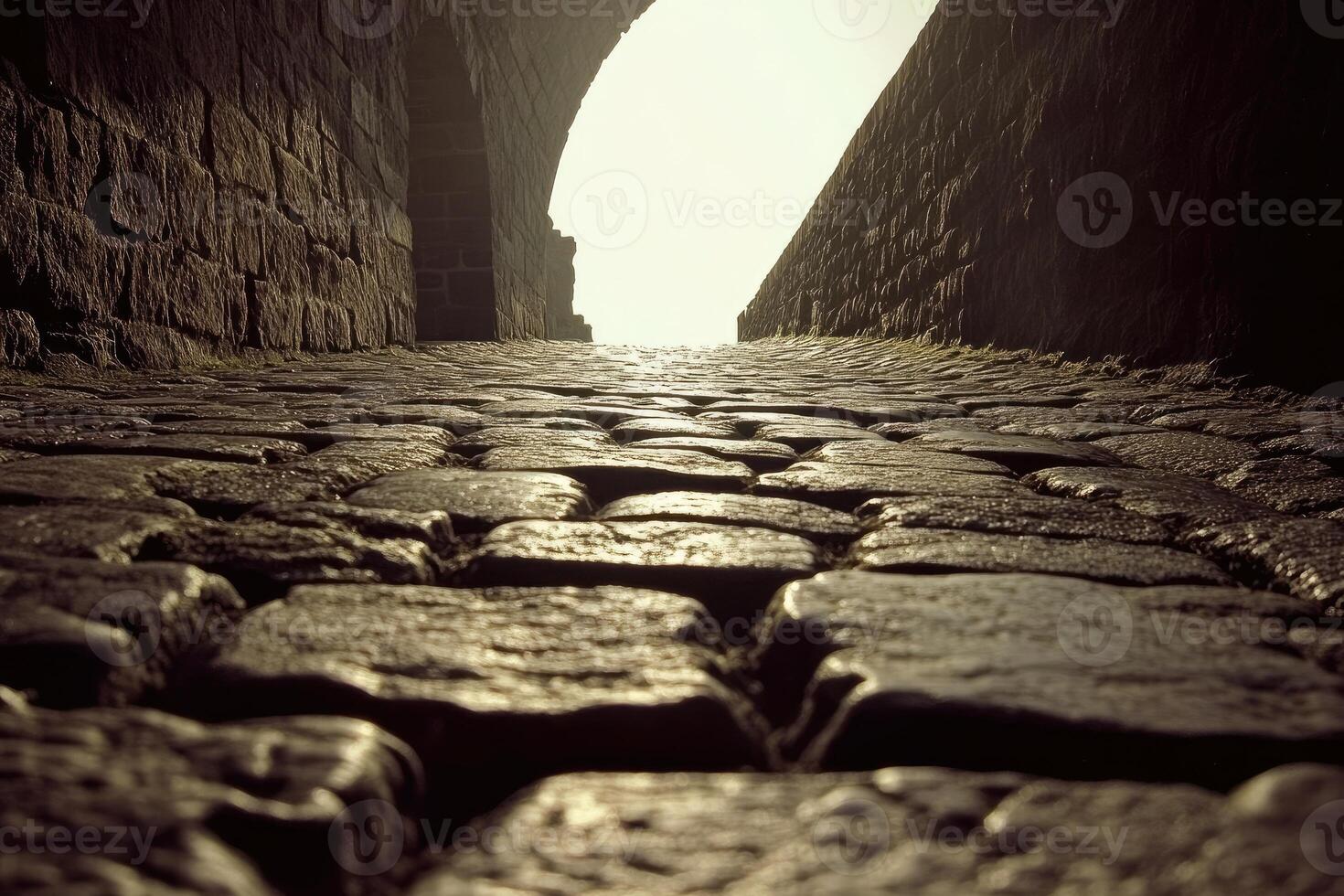 Cobbled alleyway leads to light photo