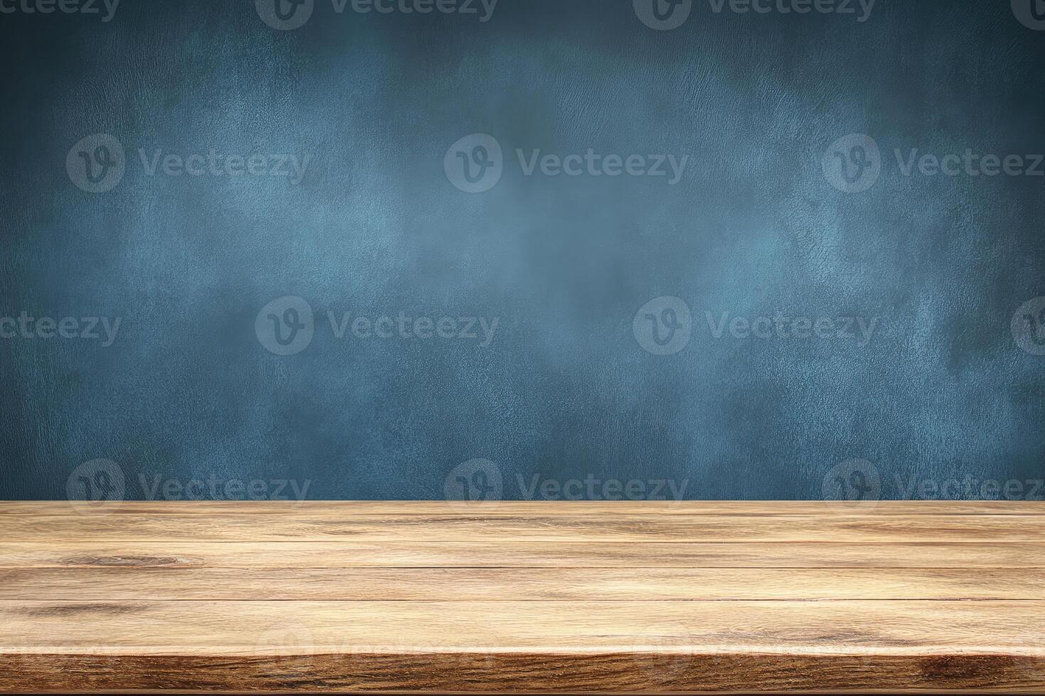 Empty wooden table in front of a textured dark blue wall photo