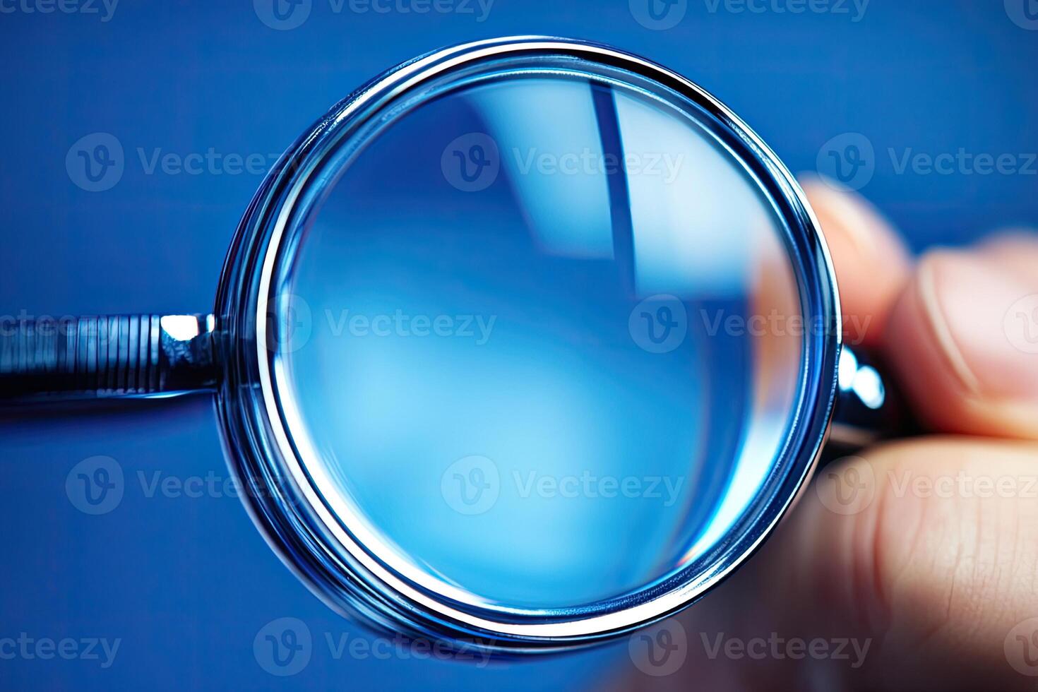 Close-up of a magnifying glass held in hand photo