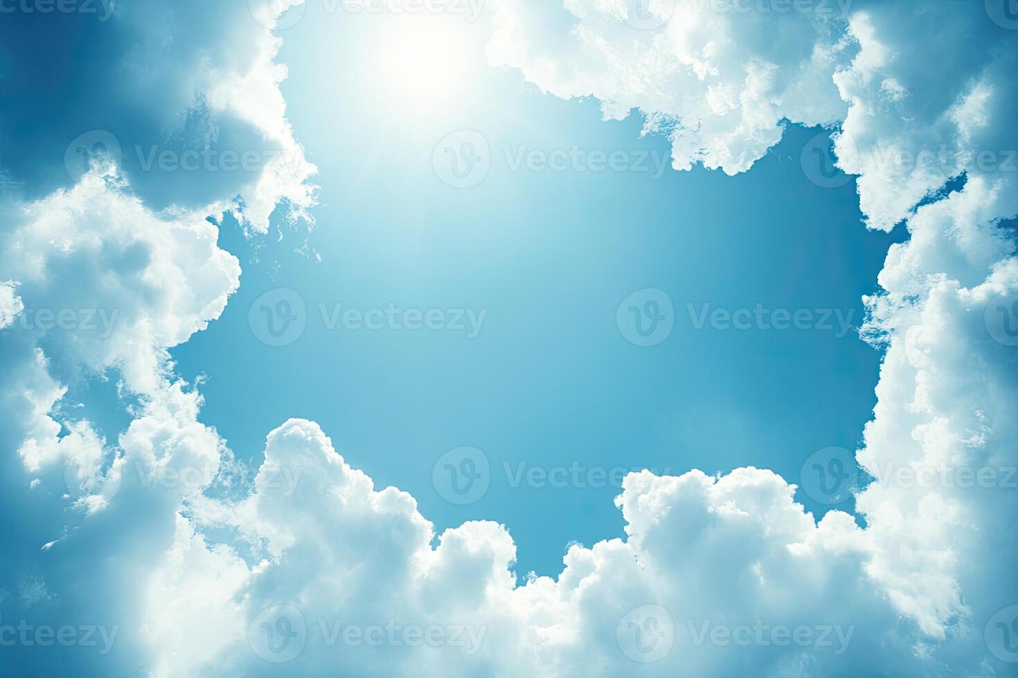 A bright sky framed by puffy clouds photo