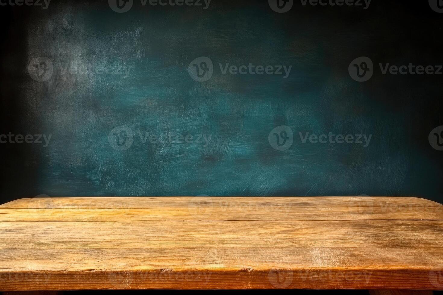 Empty wooden table against teal wall photo