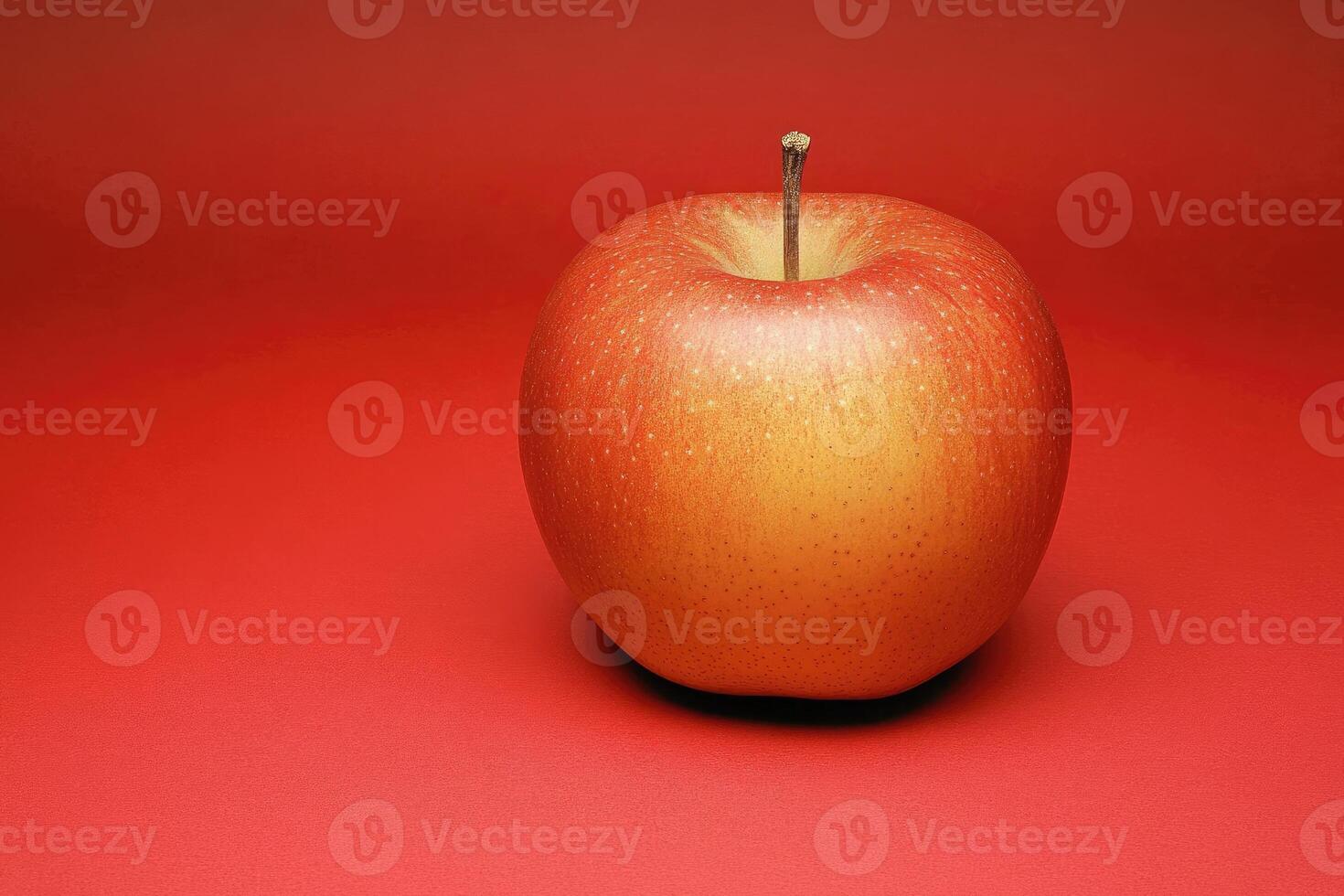 Single red apple on red background photo