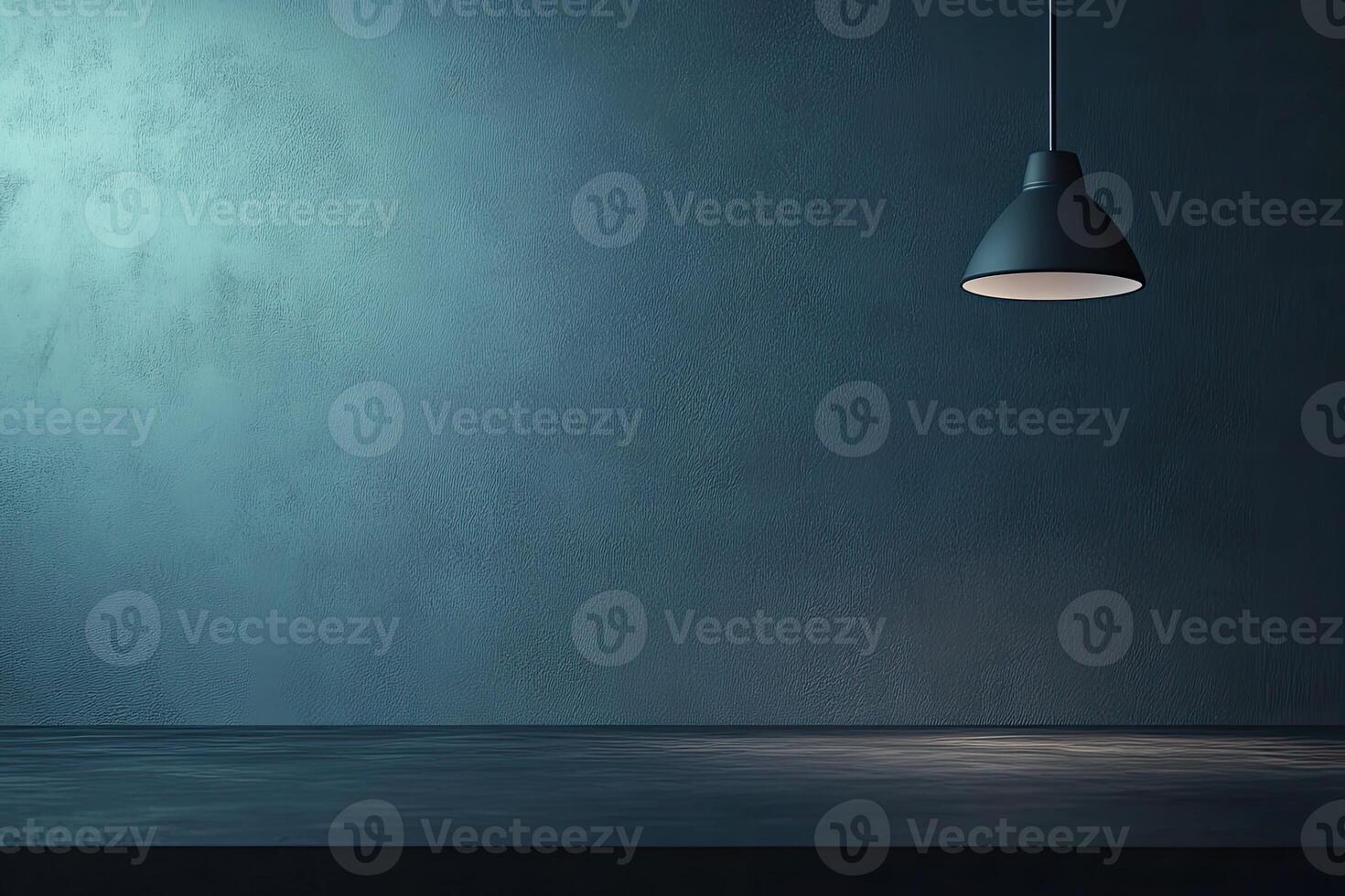Empty room with moody teal wall and hanging lamp photo