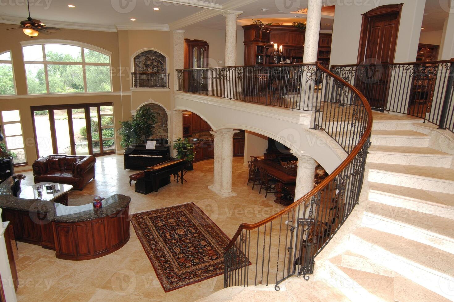 Grand Two-Story Foyer with Spiral Staircase photo