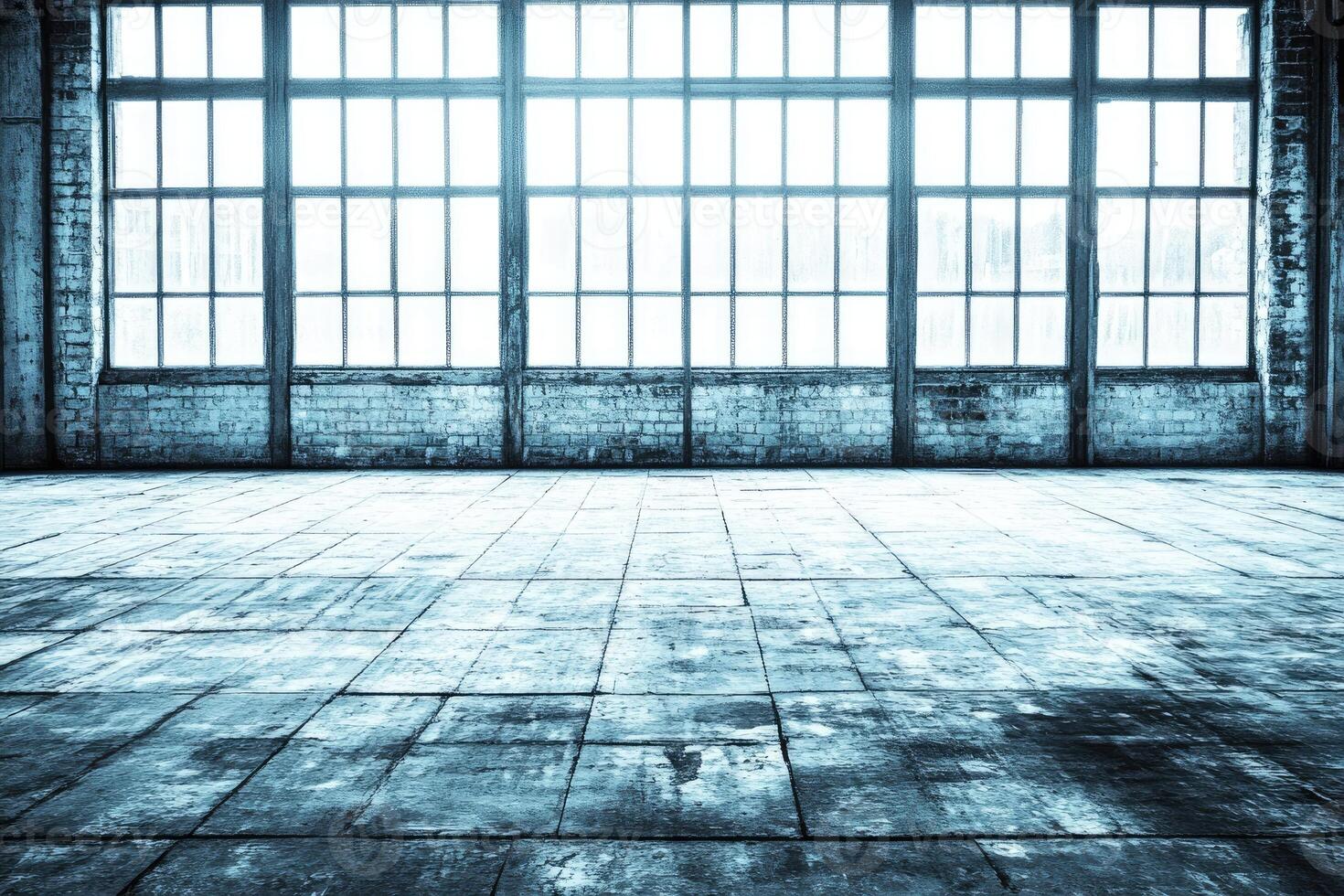 Empty industrial space with large windows photo