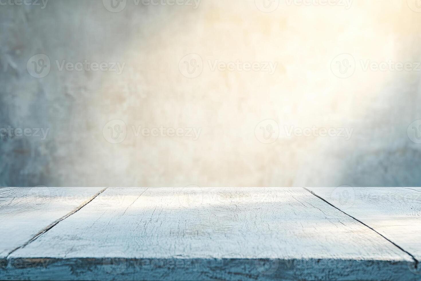 Empty light-washed wooden table against a blurred gray concrete wall photo