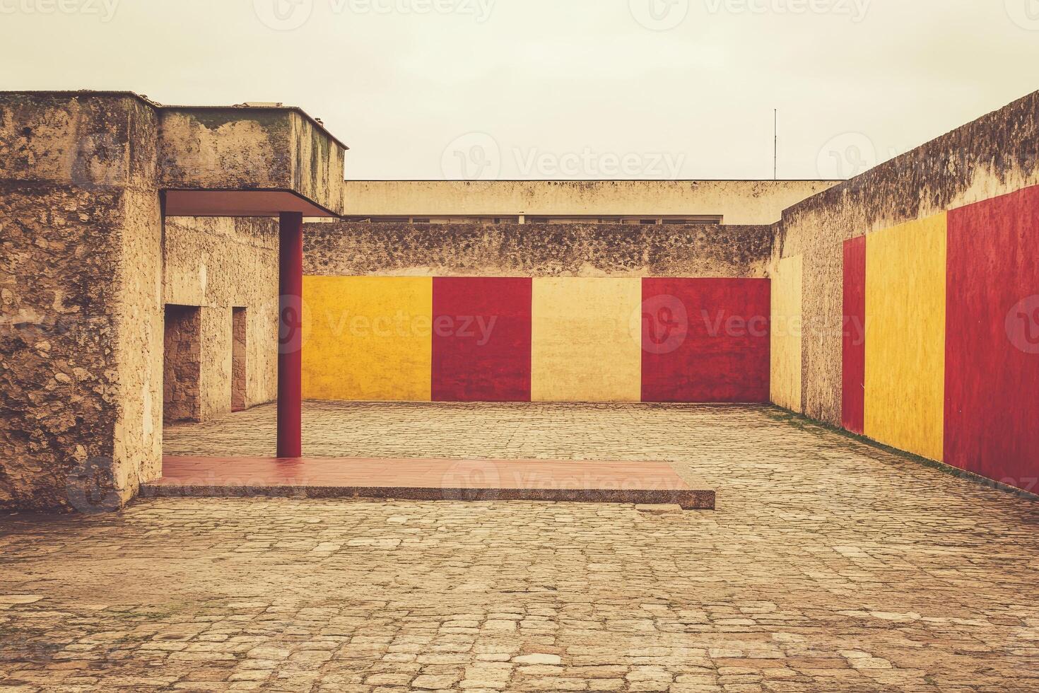Empty courtyard, with muted colors and textured walls photo