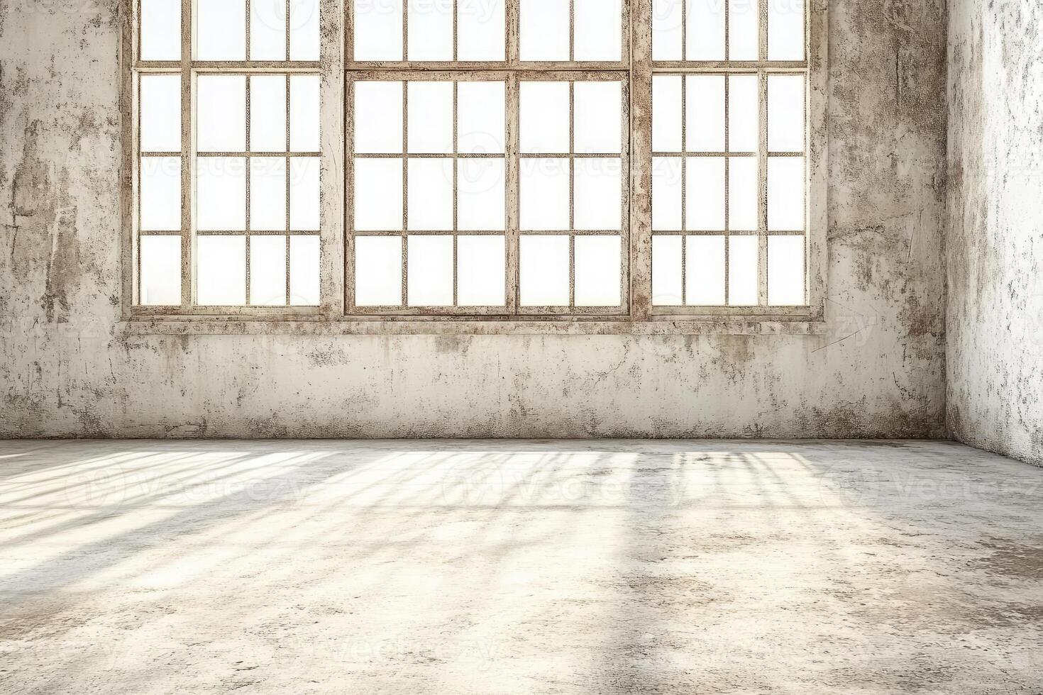 An empty room with a large window and cement floor photo
