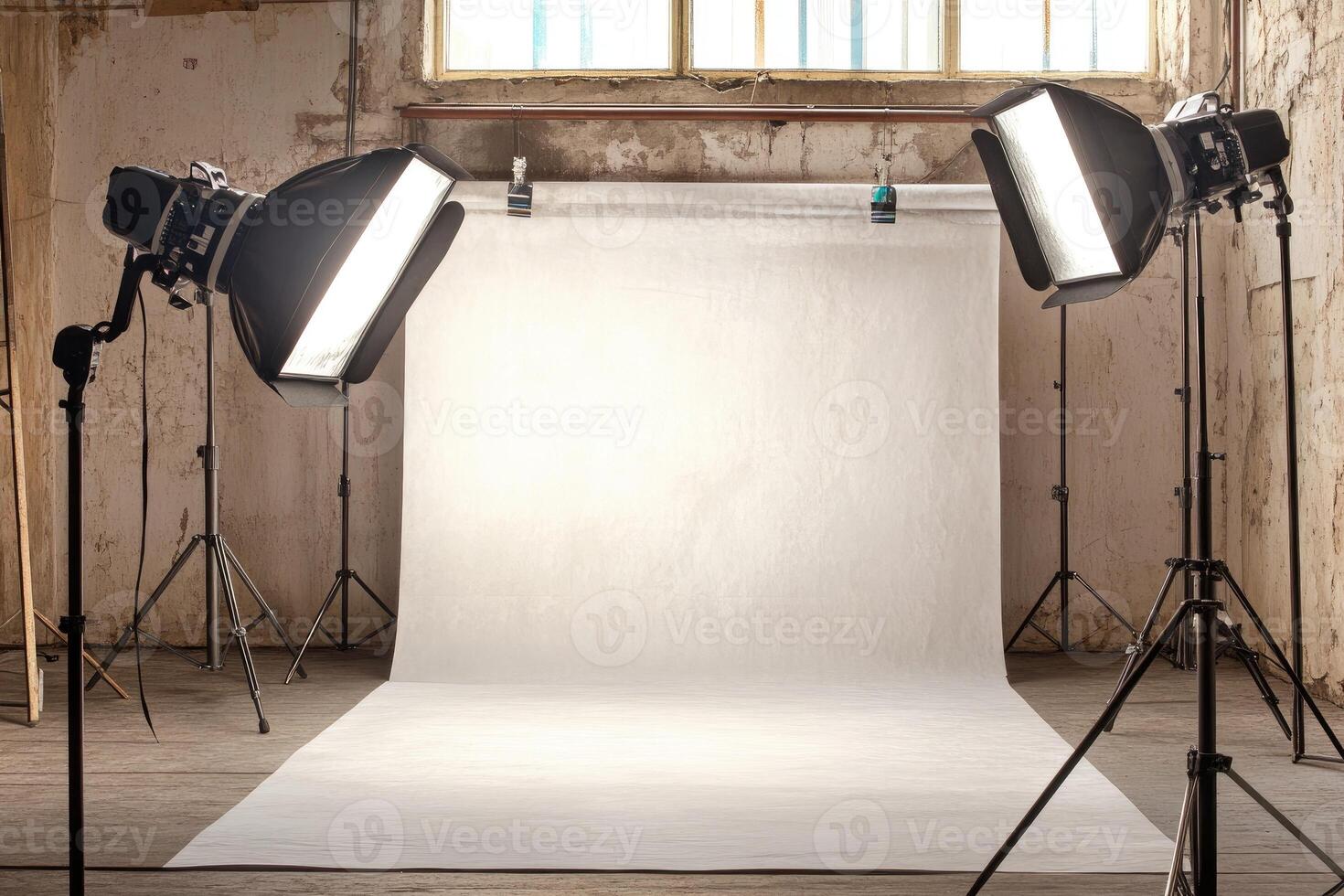 A photo studio with lights and a white backdrop