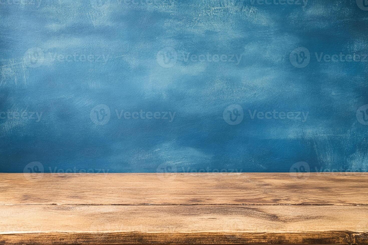 Wooden tabletop against a textured, deep blue wall photo